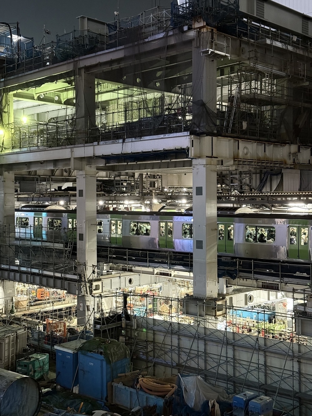A train in the middle of a very under construction Shibuya station in Tokyo.
