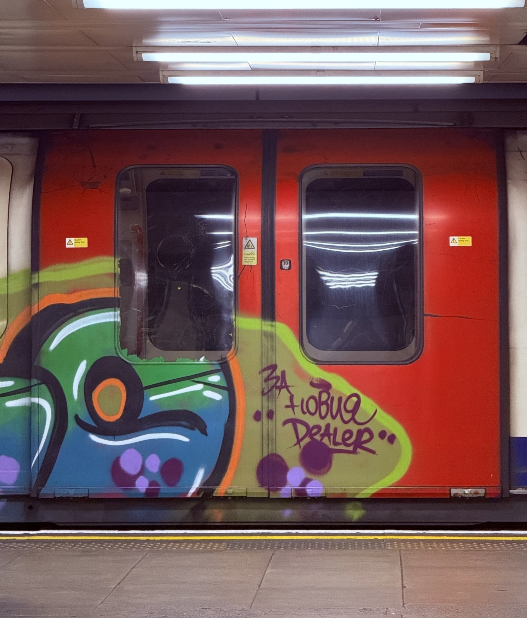 Graffiti painted doors of a tube train.