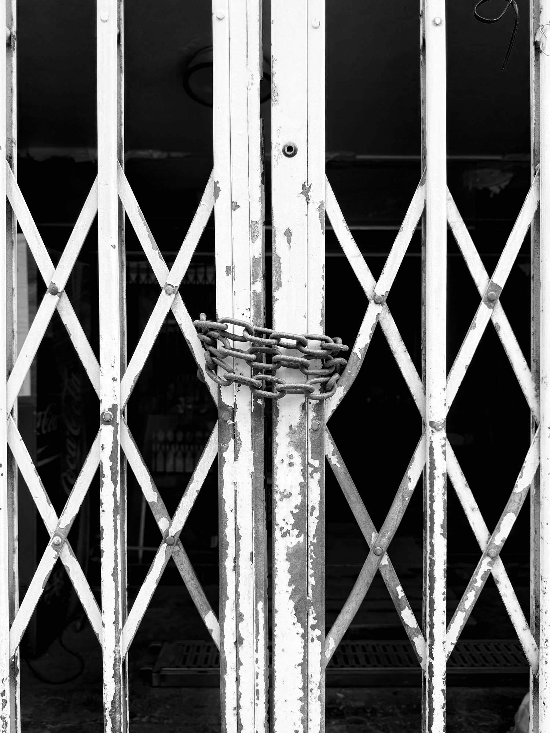 Sliding metal gates locked shut with a chain.