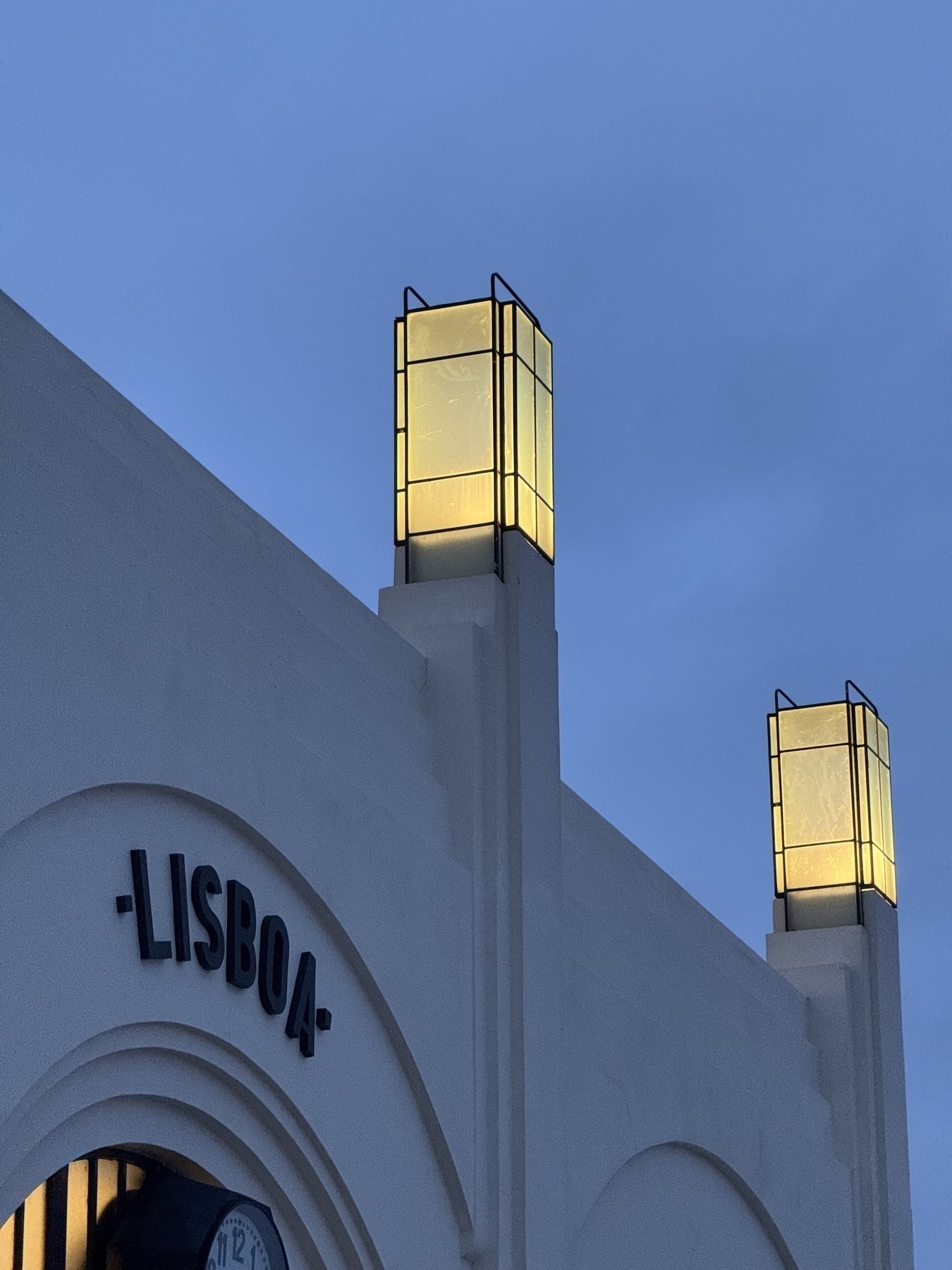 Art deco lamps on the top of the ferry terminal in Lisbon at dusk.