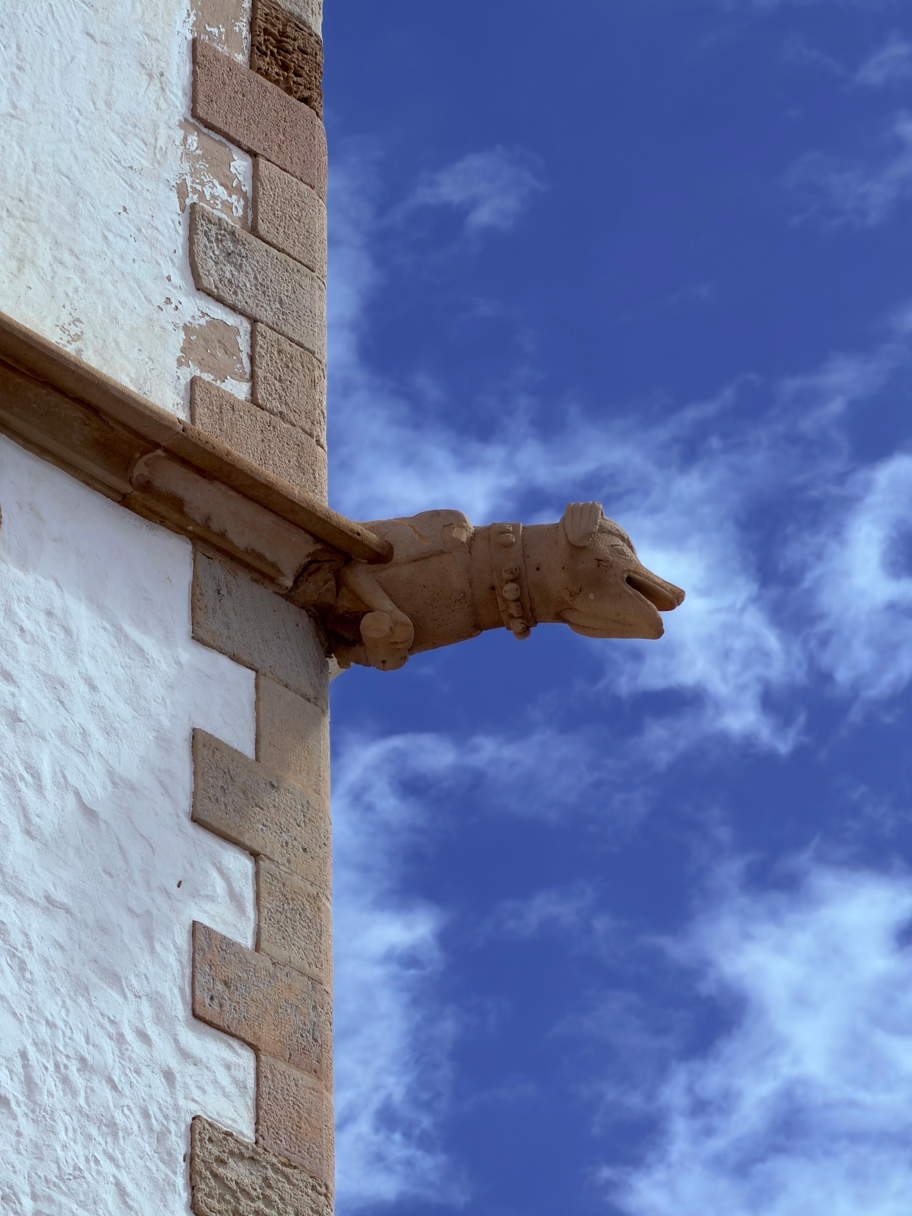 A stone grotesque sticking out of a wall.