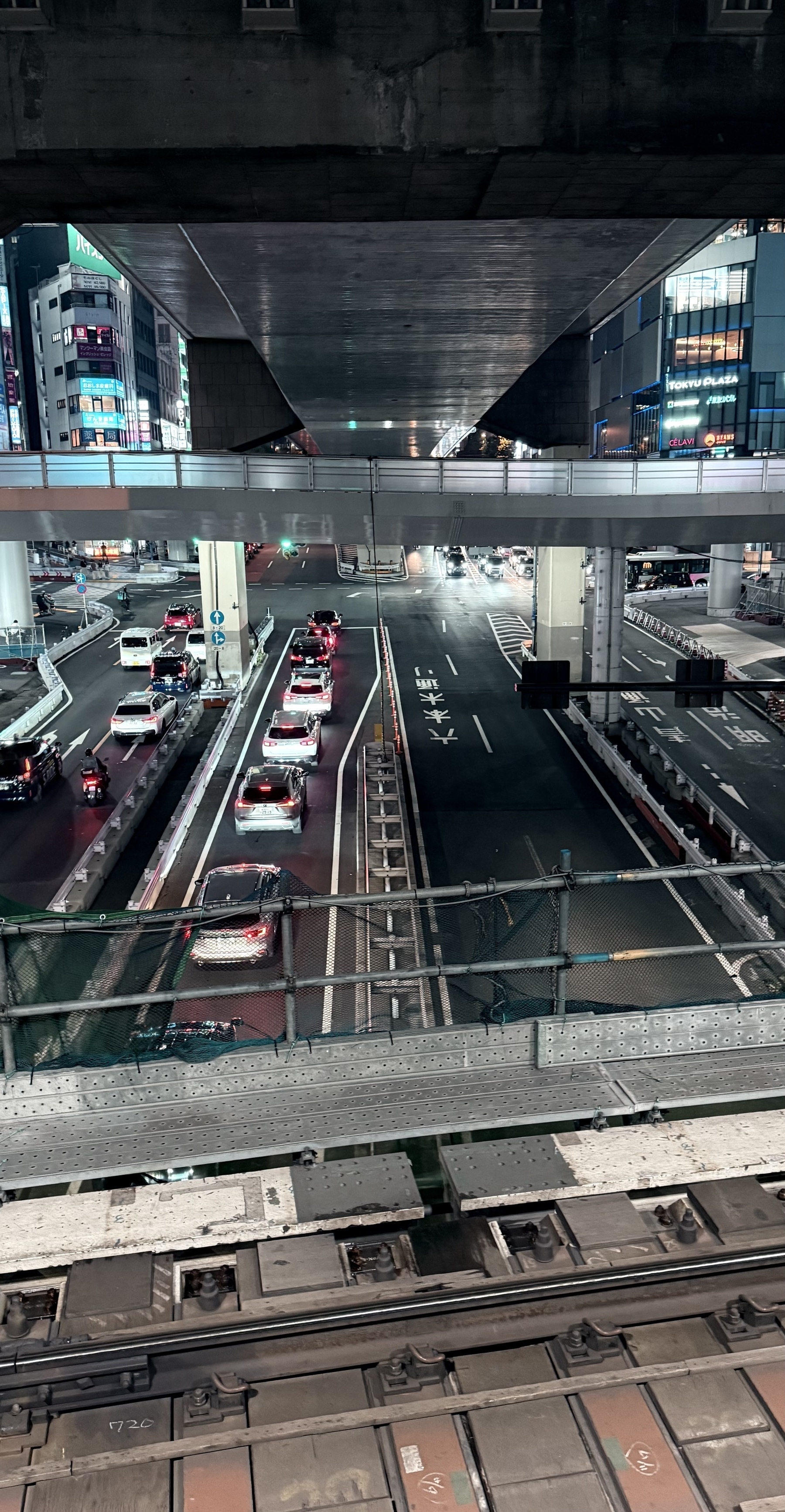 Looking across a railway track at the road below.