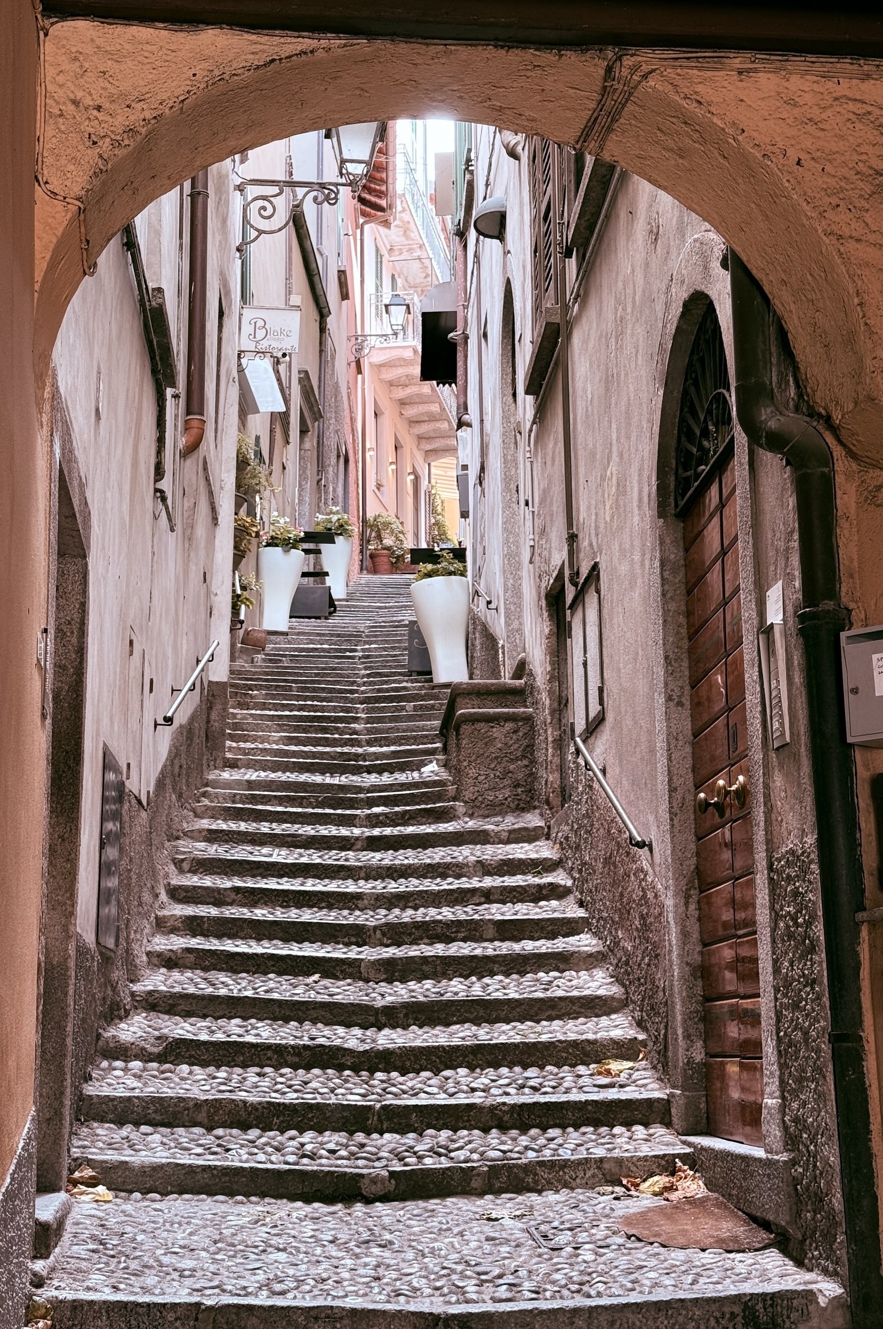 A narrow staircase alley, seen through an archway.