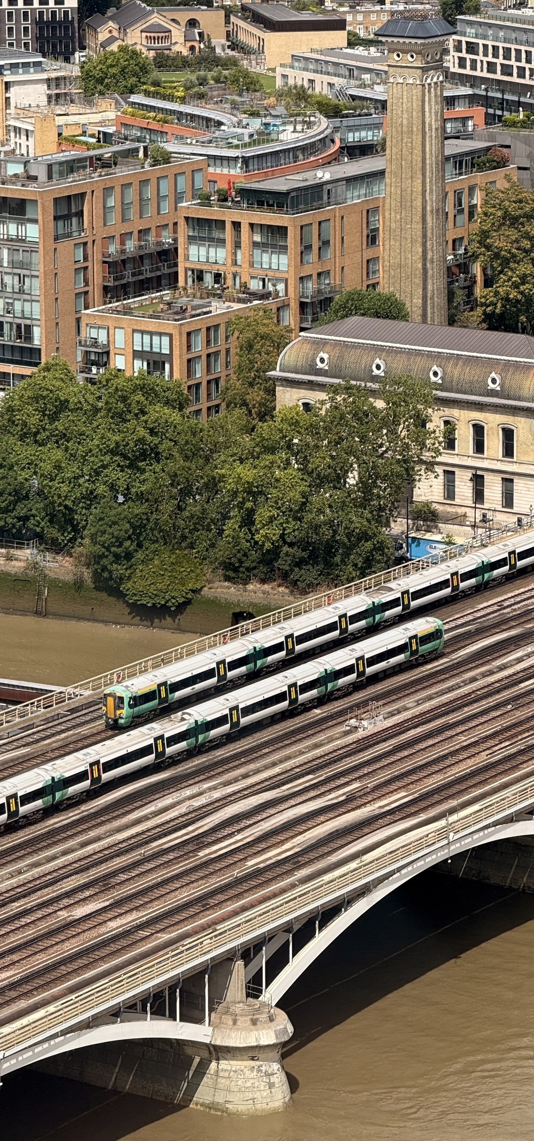 Two trains crossing a bridge across the river Thames.