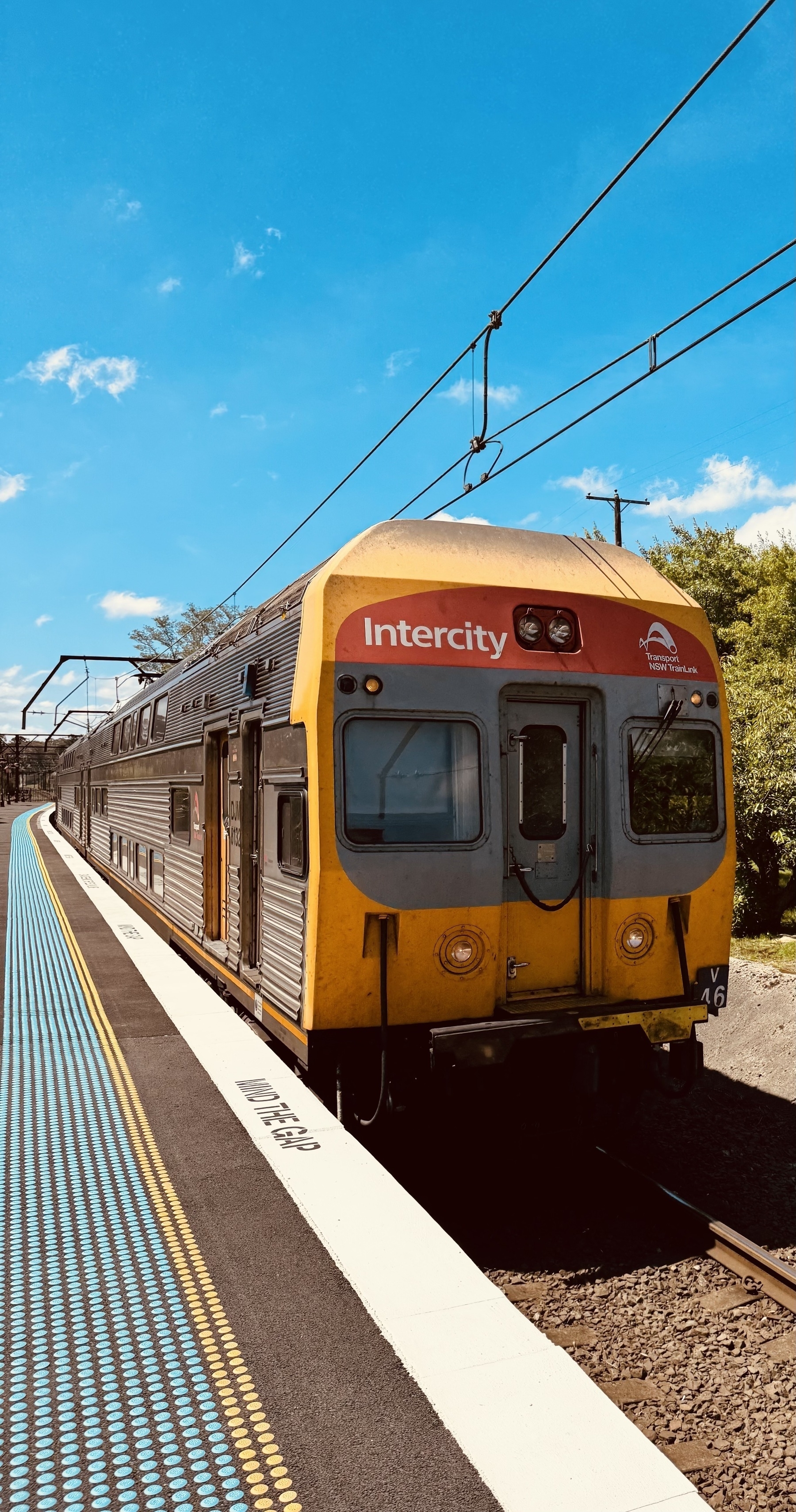 A double decker Intercity train arriving at the platform.