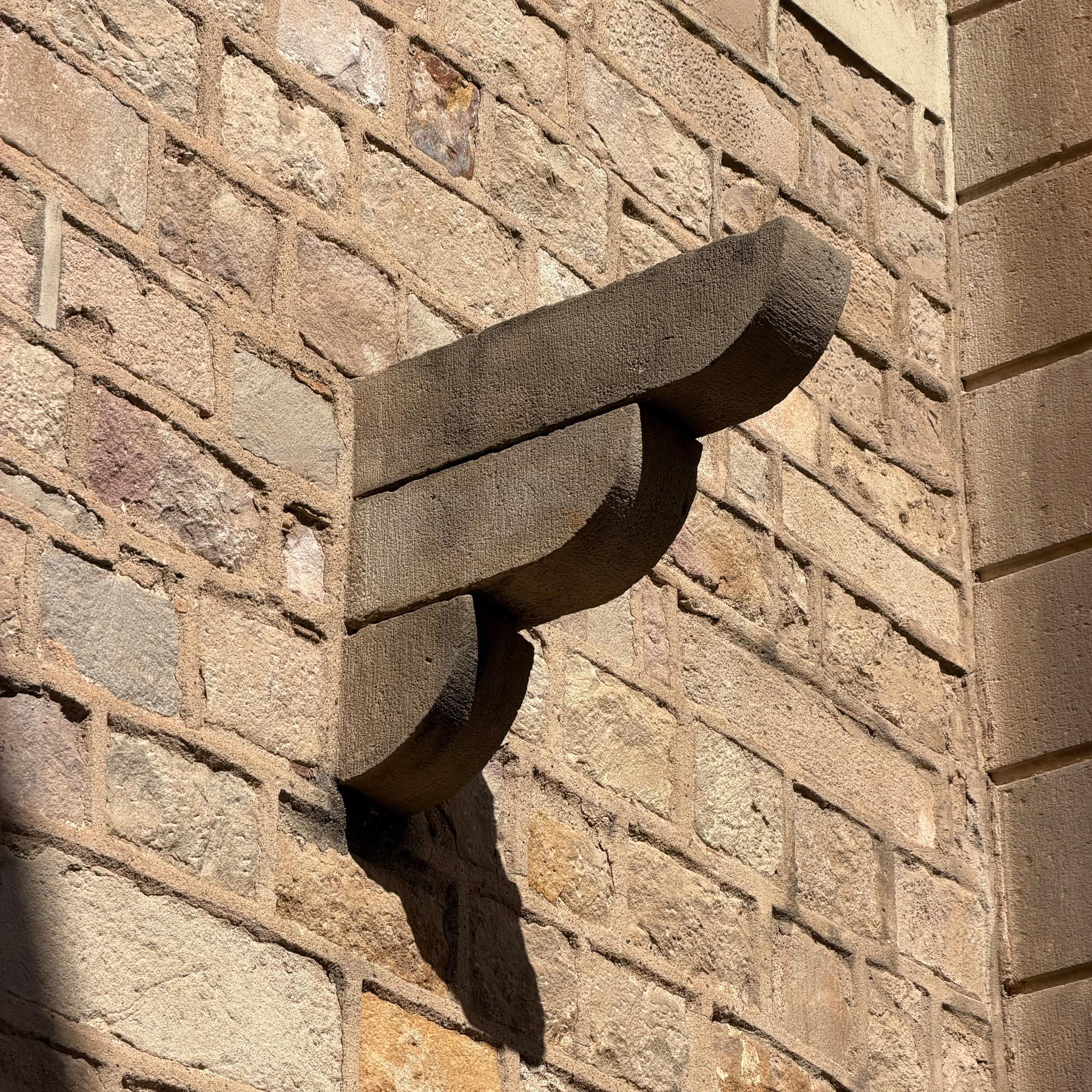 A stone support jutting out of a stone wall.