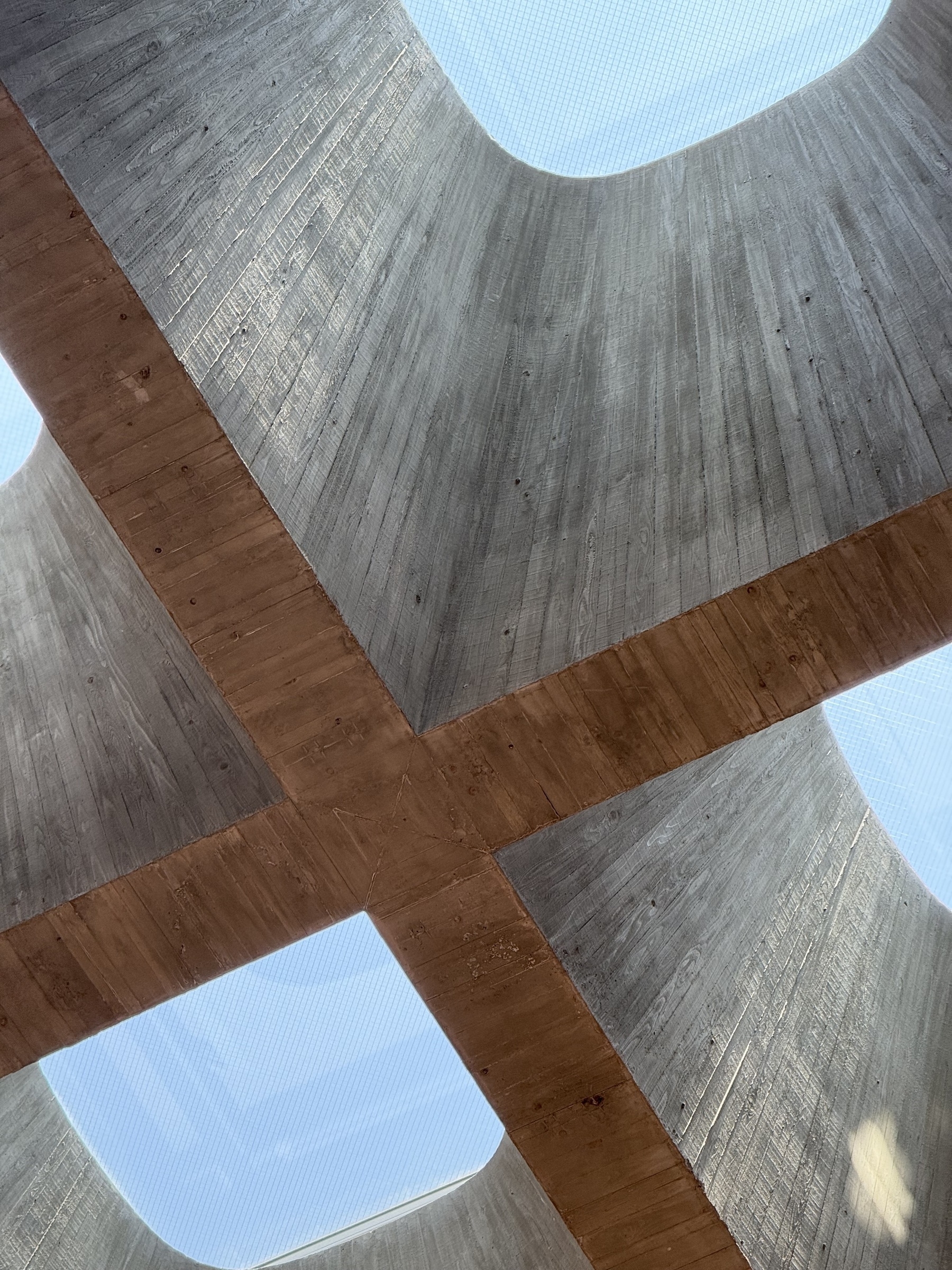 Chunky concrete skylights with a blue sky above.