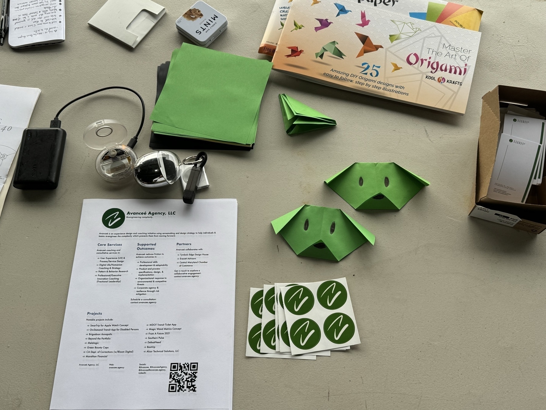 several pieces of origami on a table with a few few other marketing materials