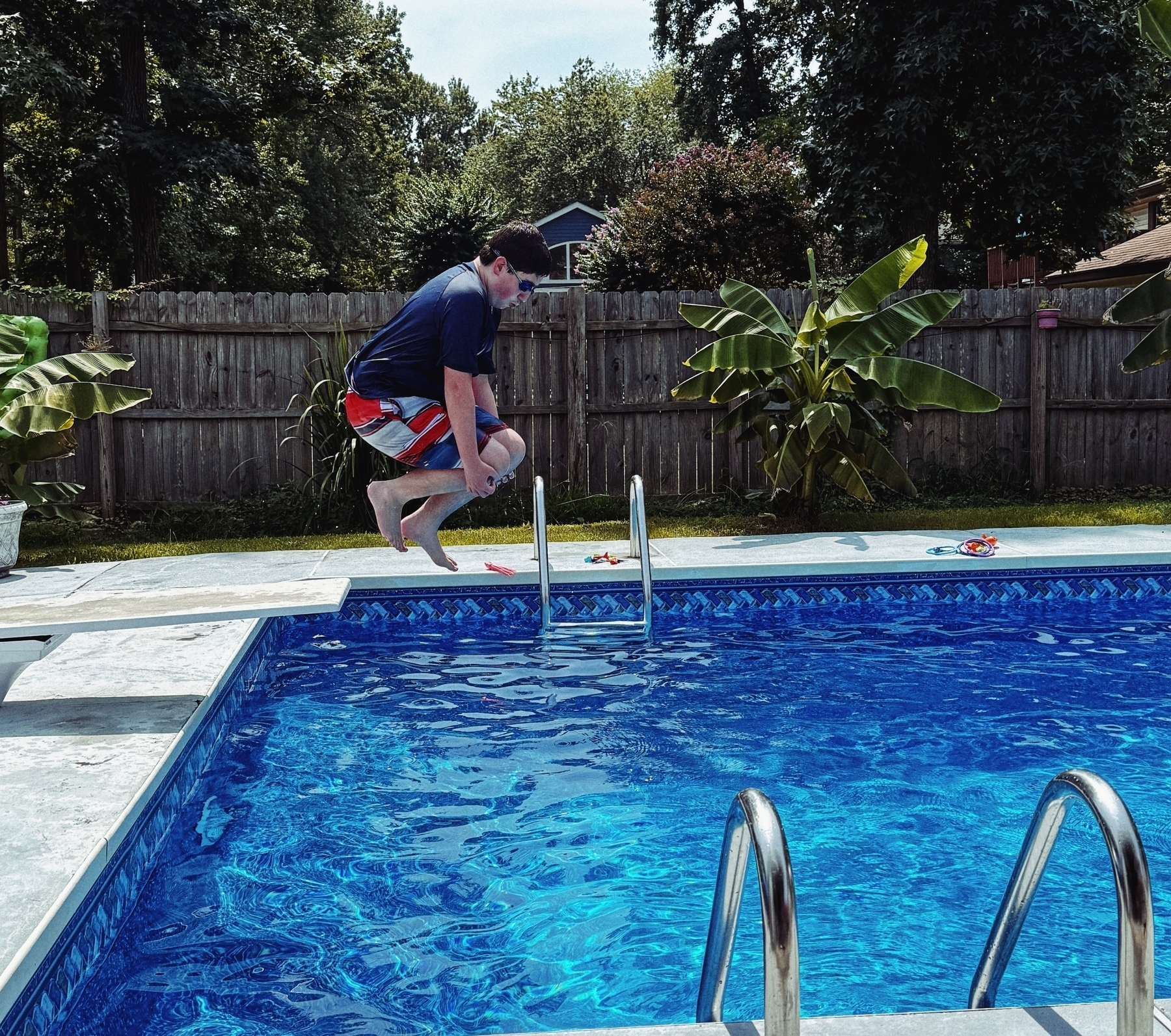 Kiddo doing a cannonball into a pool