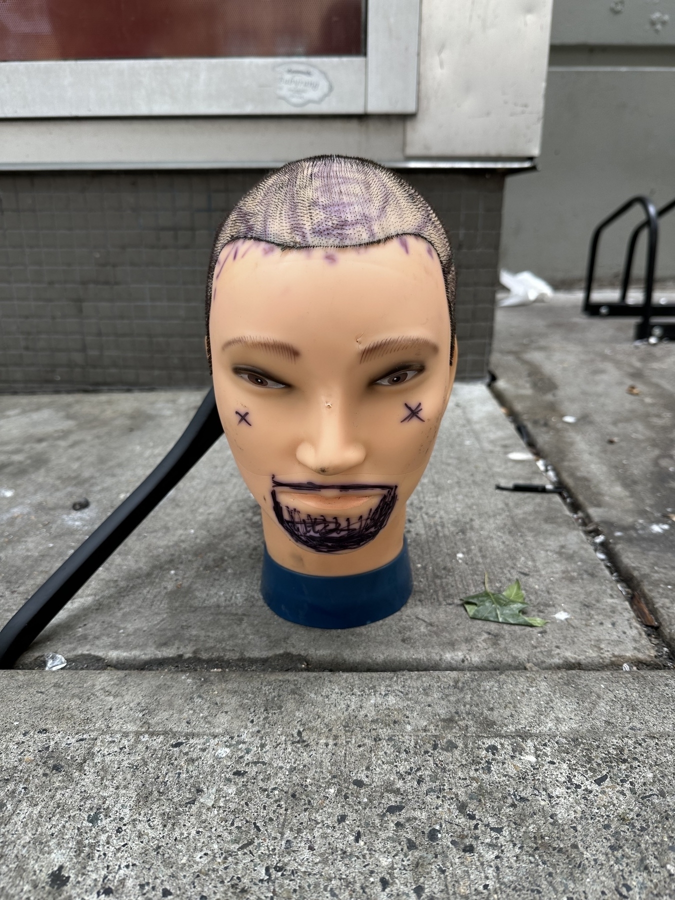 Random head on sidewalk.