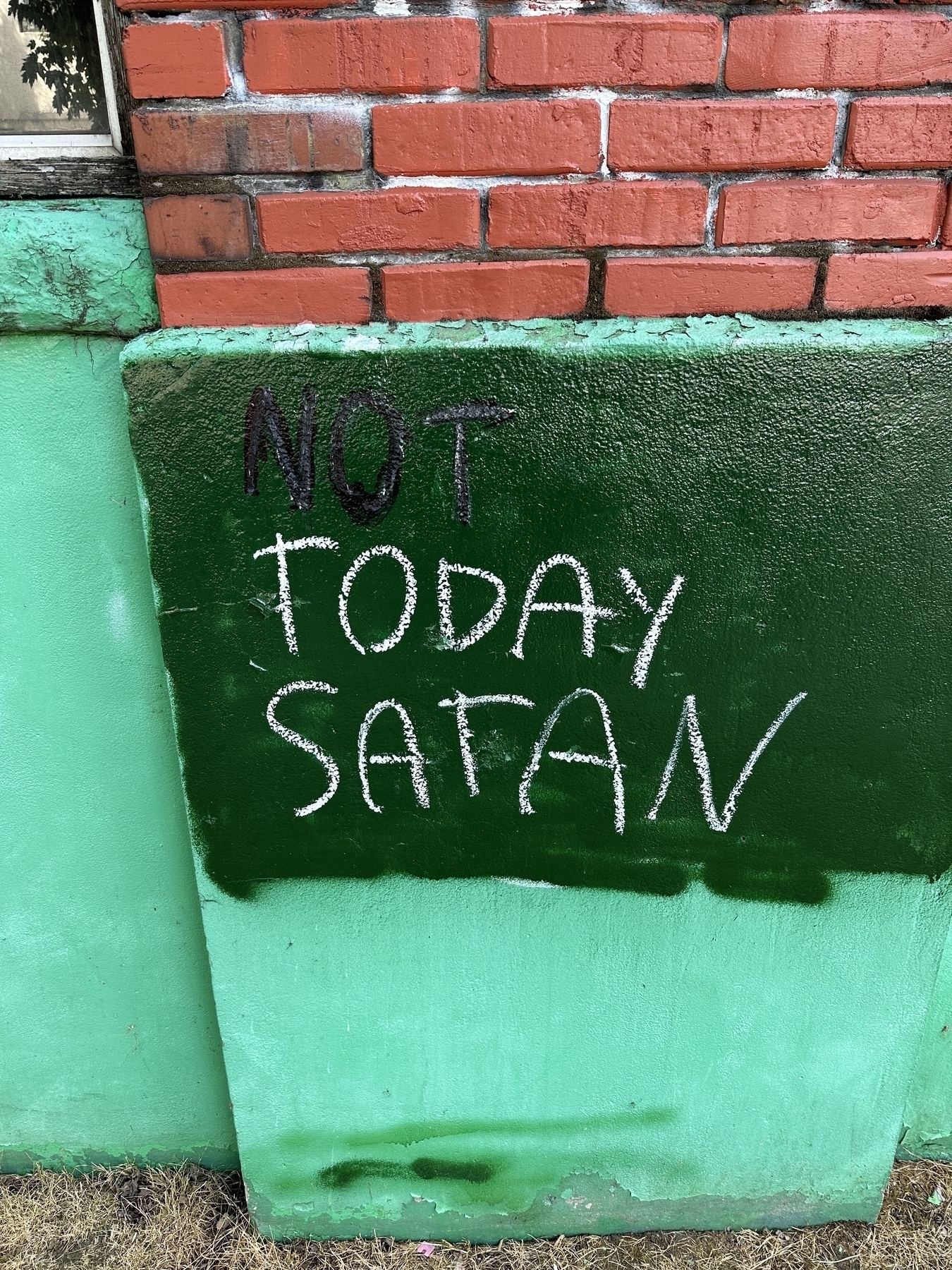 Graffiti on building “Not Today Satan”