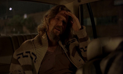 A scene from The Big Lebowski where Jeff Bridges is in the back of a cab, holding his head, asking the driver to change the music.