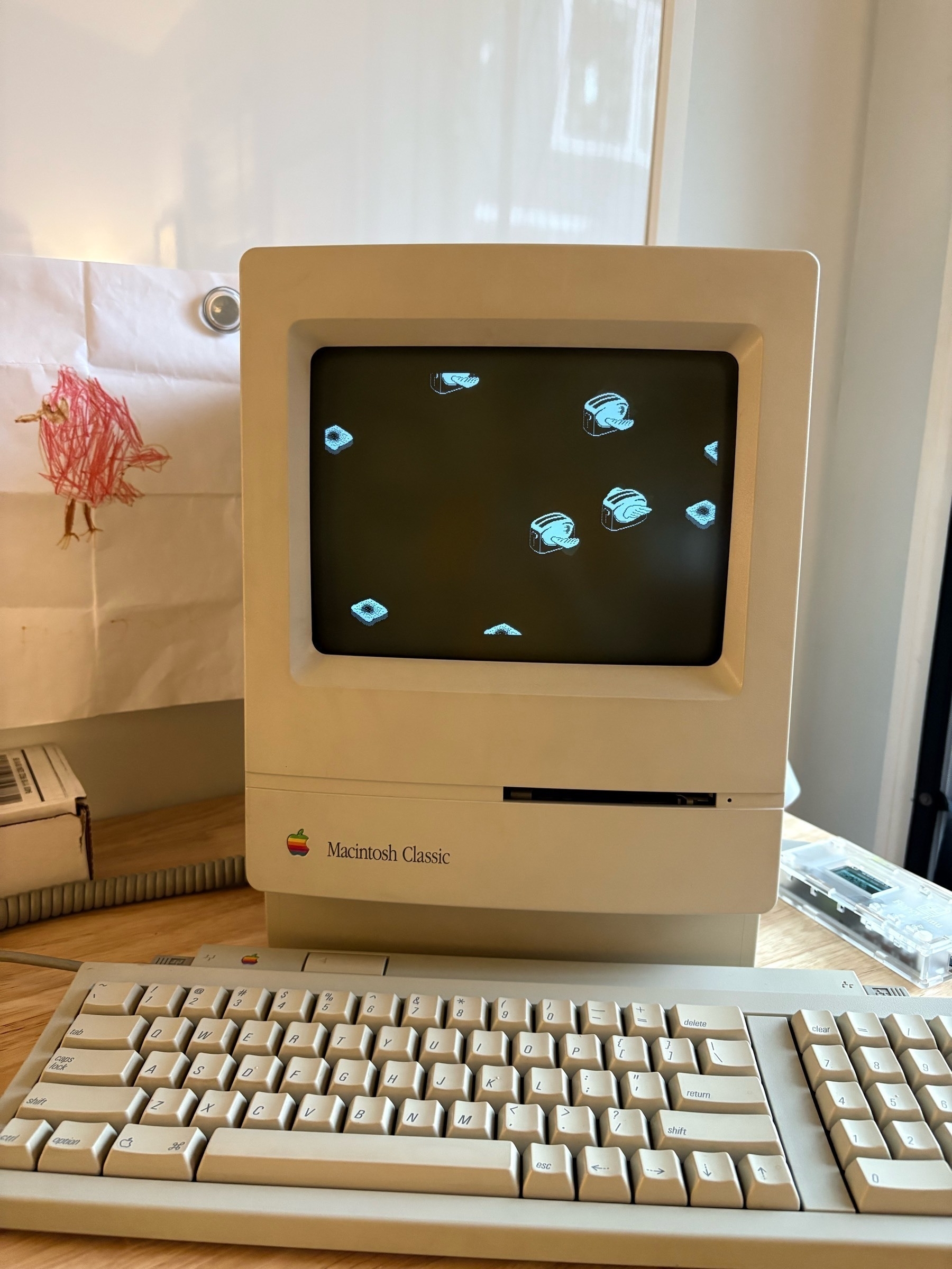 A Macintosh Classic with the Flying Toasters screensaver.