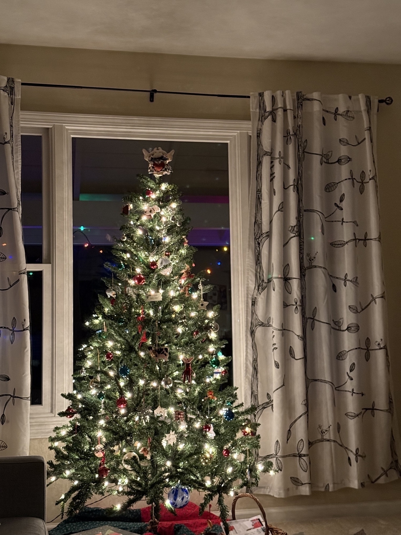 A small Christmas tree with white lights and an eclectic collection of ornaments accumulated over half a lifetime 