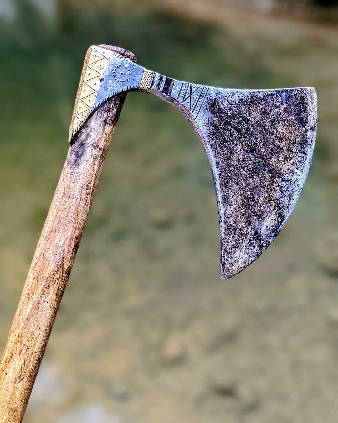 brown wooden handle axe in grayscale photography