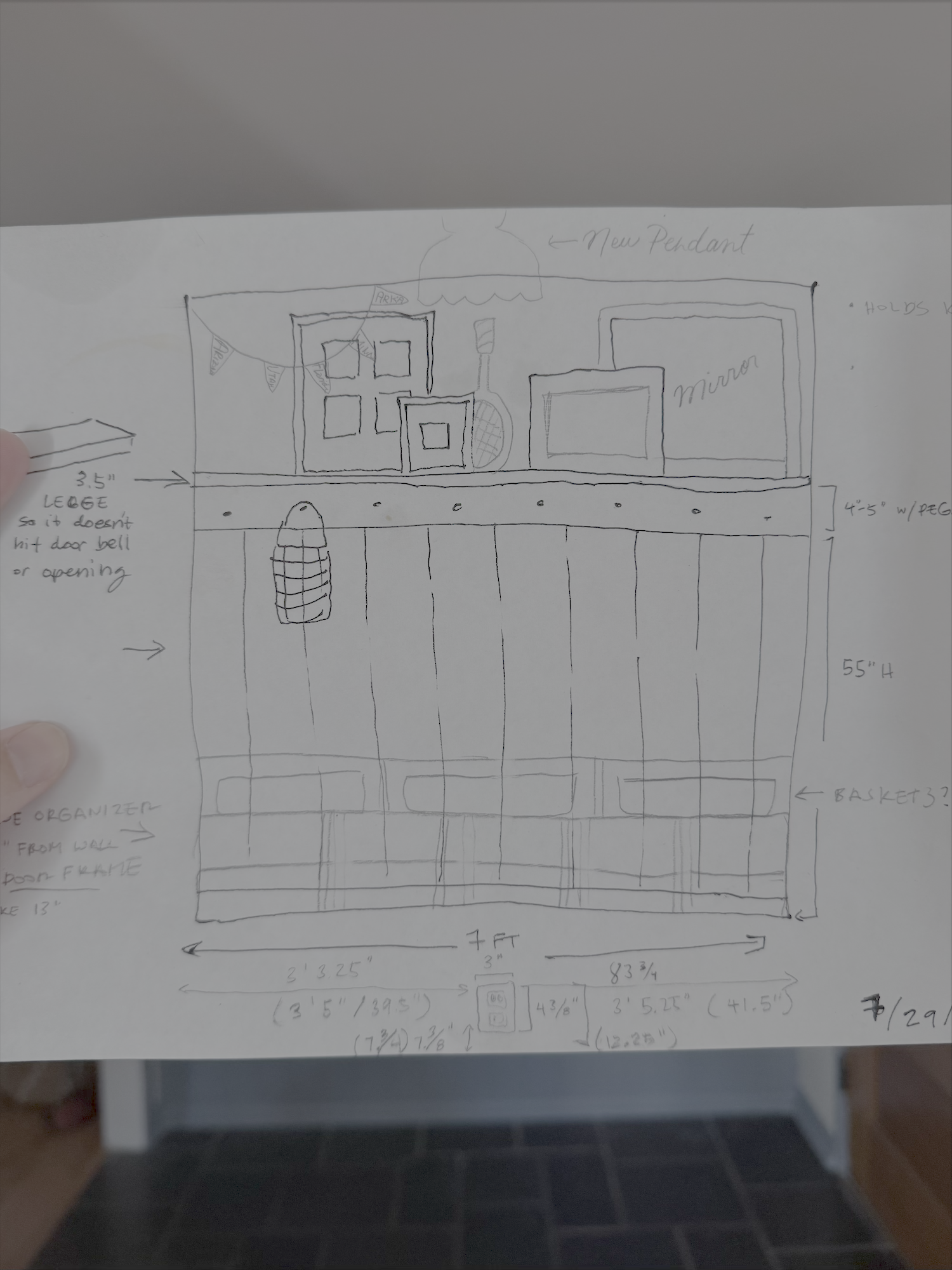 A hand-drawn sketch depicts a room layout with furniture, decorations, storage baskets, and measurements.