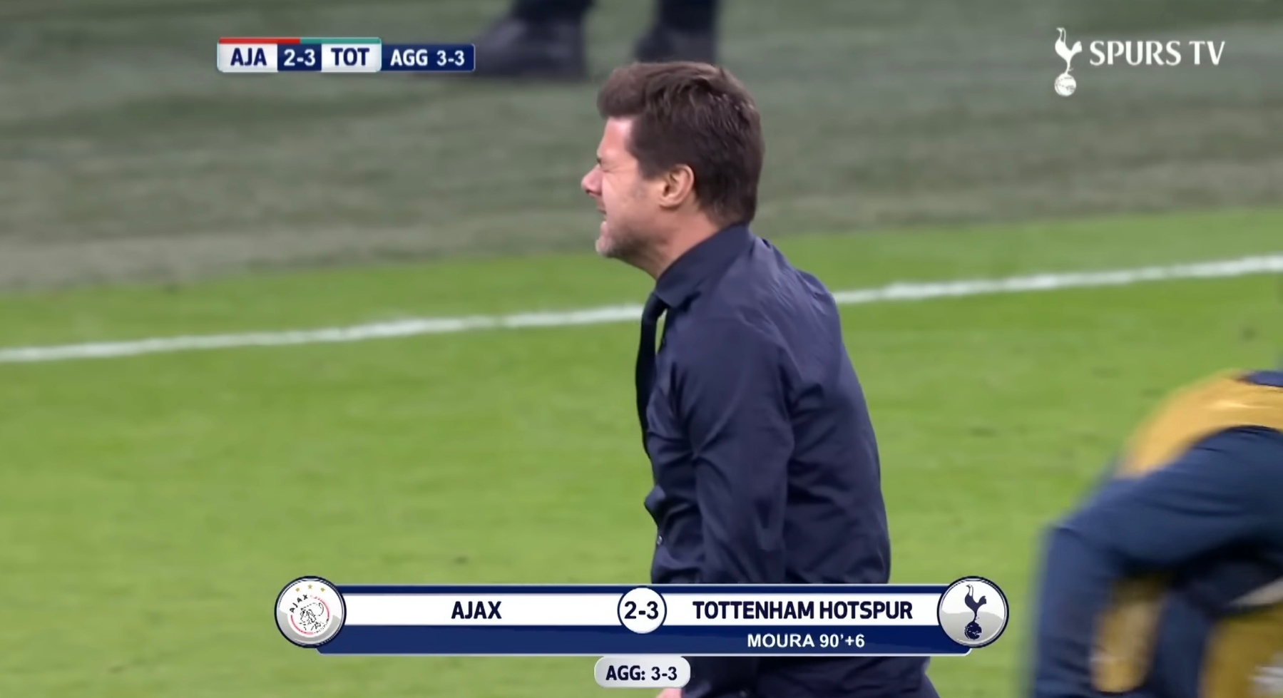 A person on a soccer field is celebrating while a scoreboard shows Ajax 2-3 Tottenham Hotspur with an aggregate of 3-3.