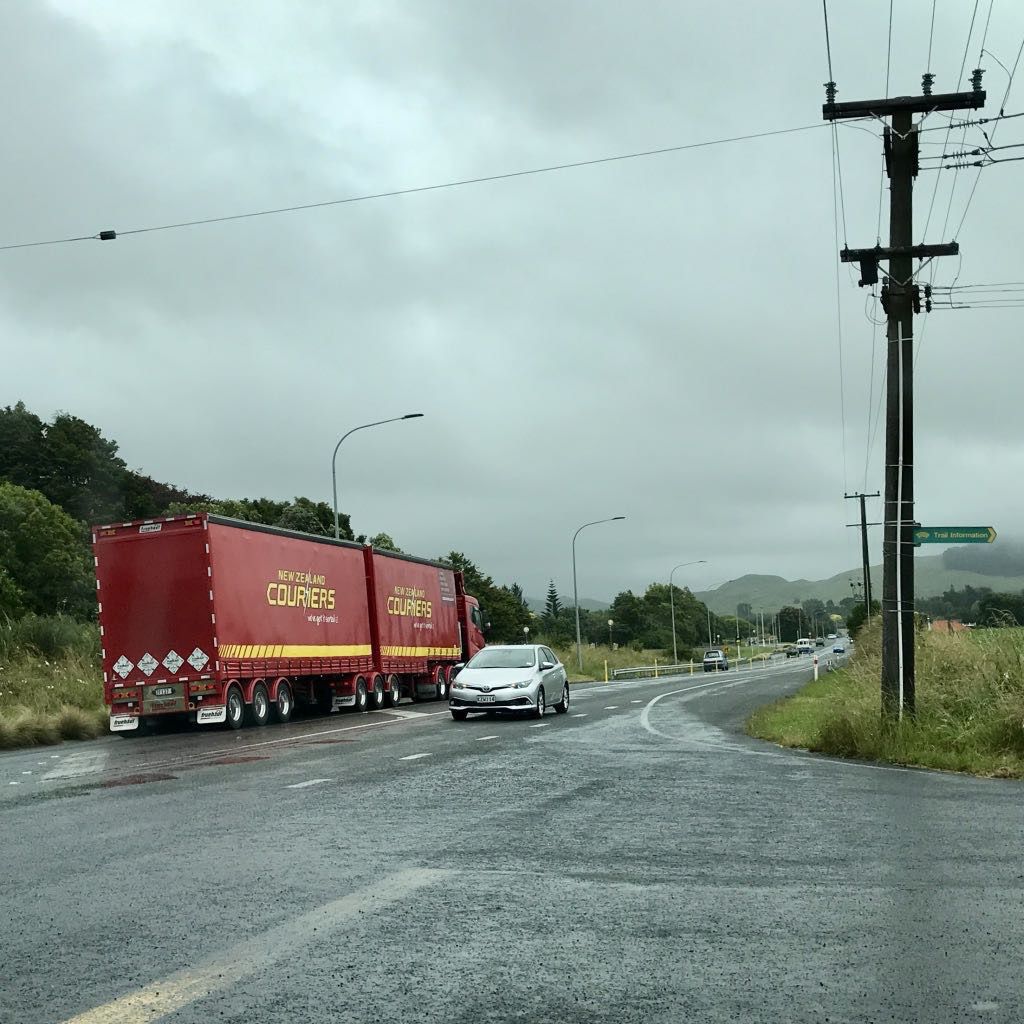 Intersection with truck going south and car going north. 