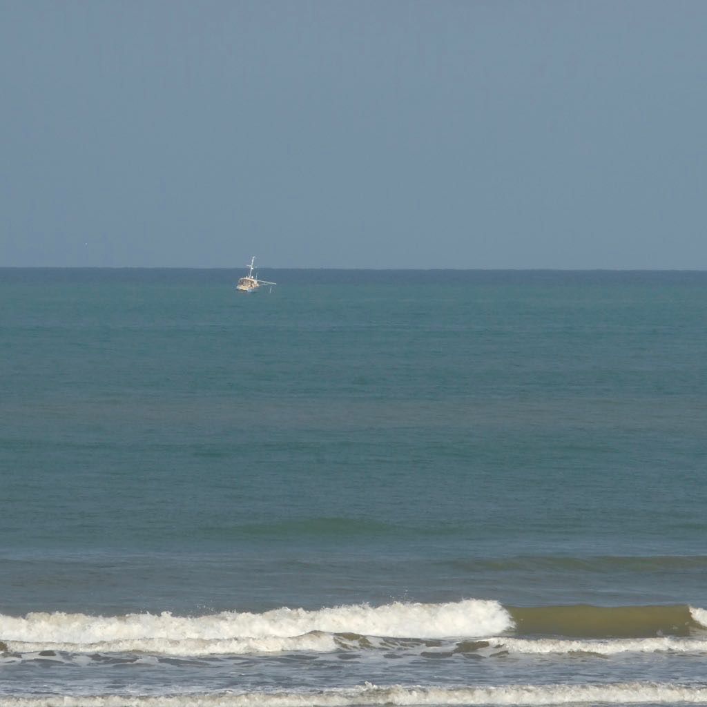 A small boat just off-shore. 