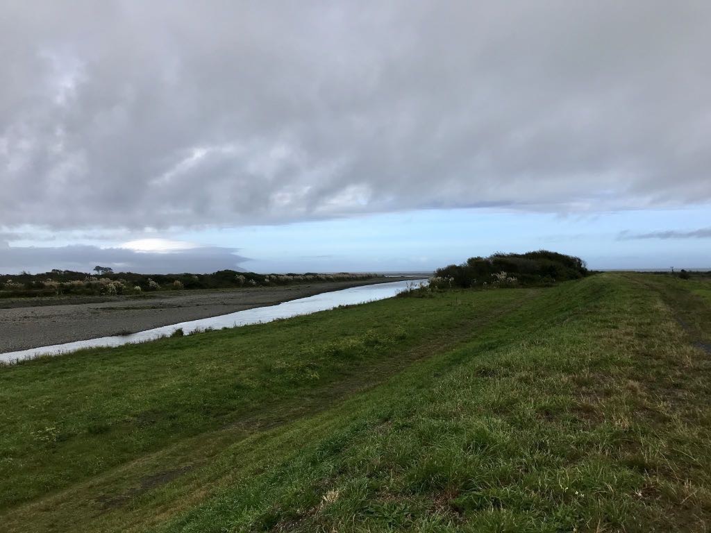 Looking west along the Ōtaki river with the sea in the distance. 