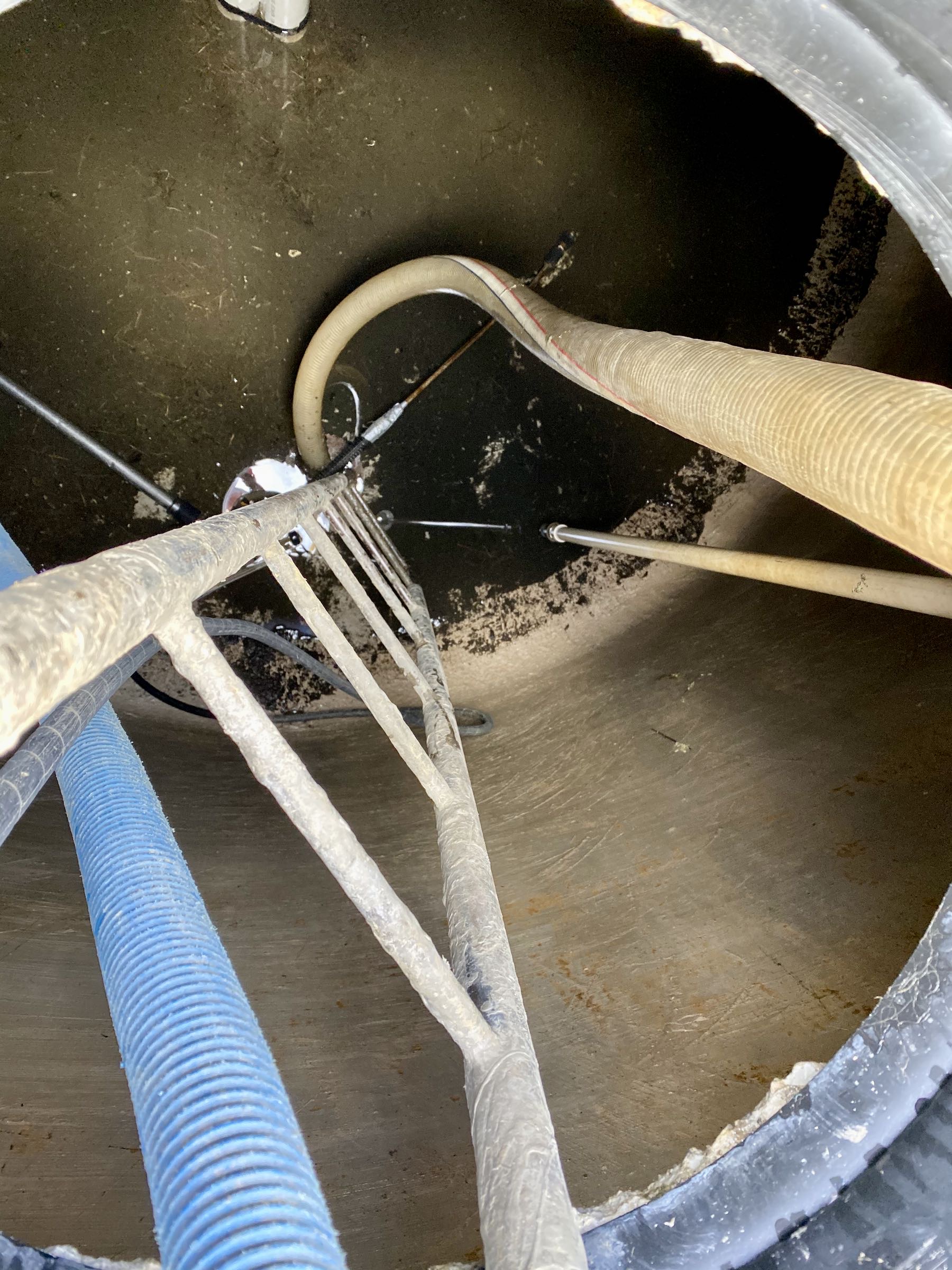  Gunge on the floor of the tank, plus assorted hoses and a ladder. 