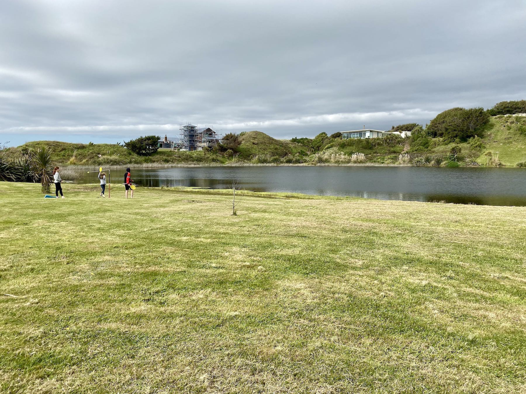 A few of the kids play tetherball by the lake. 