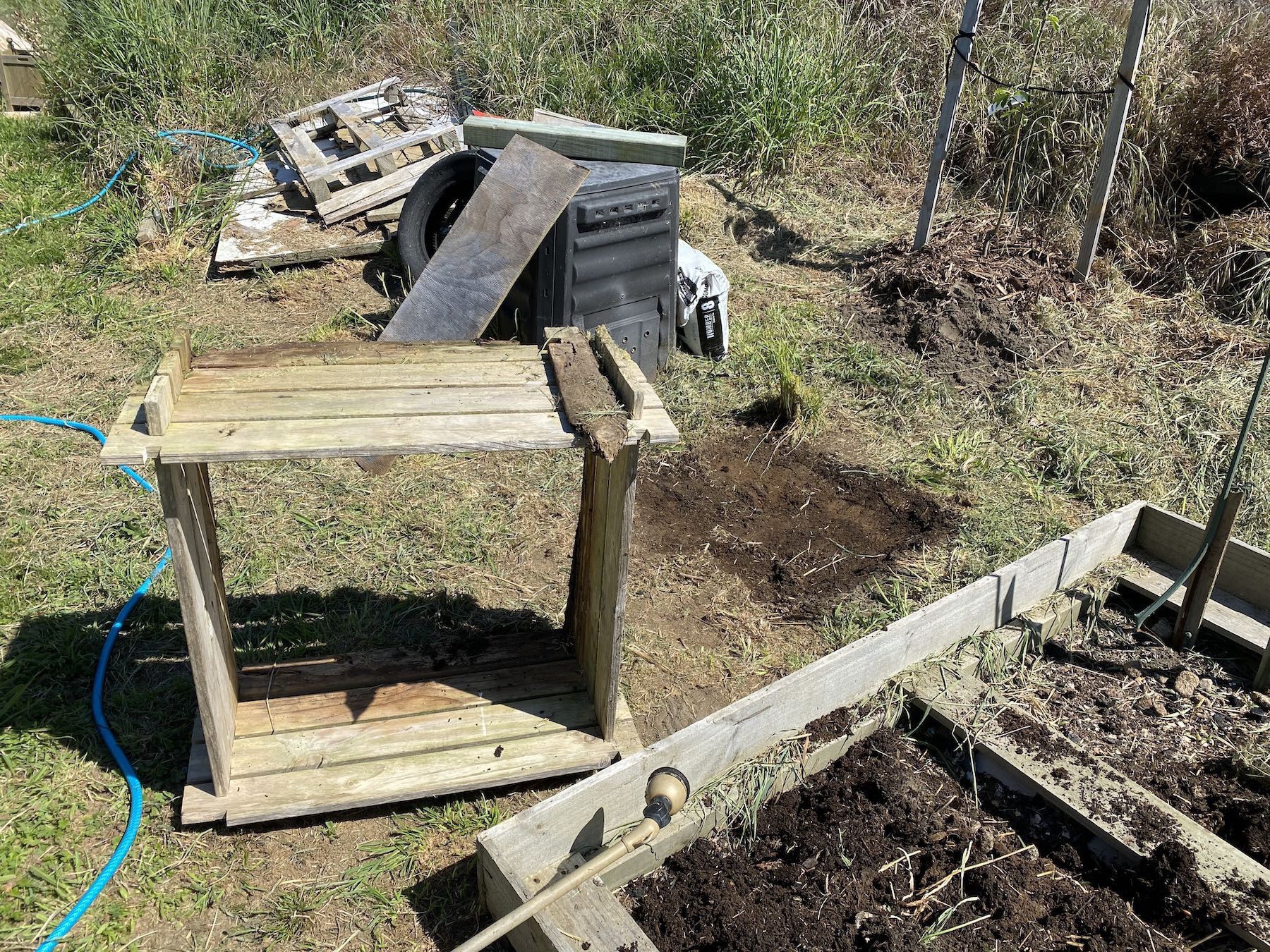 Empty compost frame and corner of the garden bed where I put the compost. 