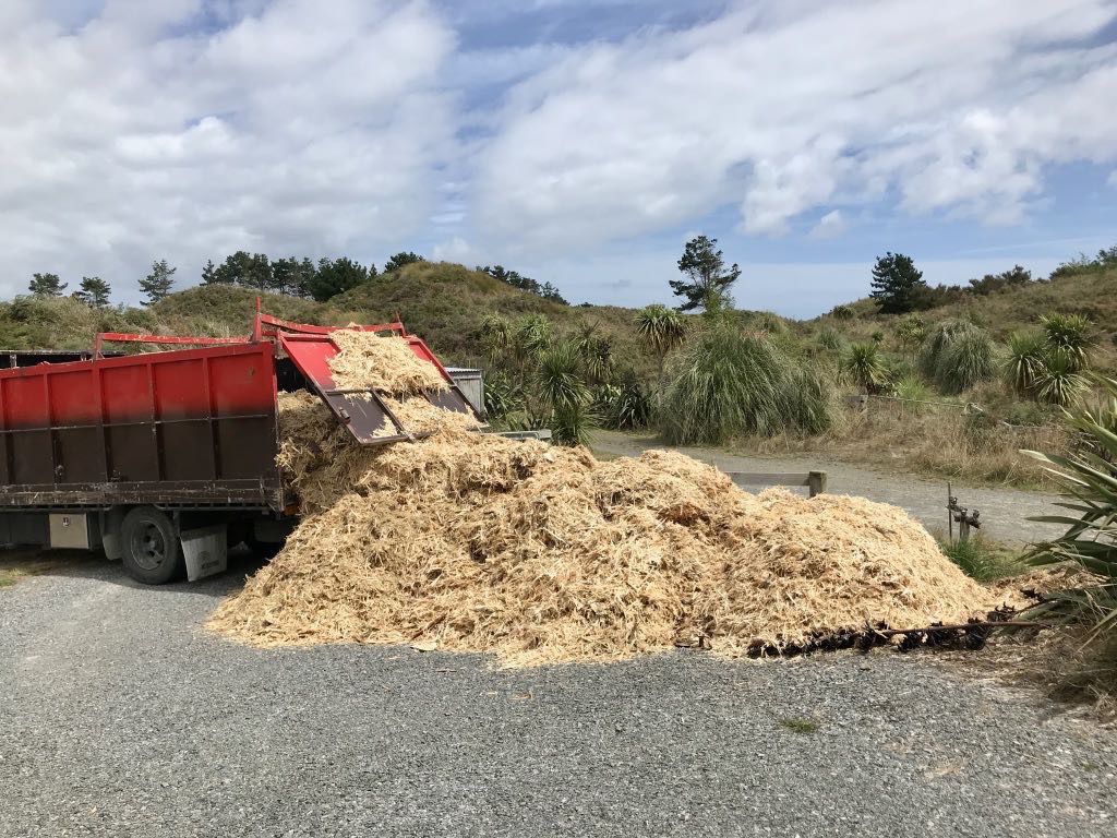 A big pile of mulch by the gate. 