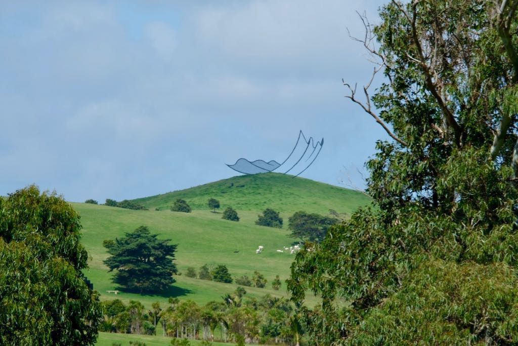 Huge sculpture on top of a hill. The sculpture looks like a deckchair. 