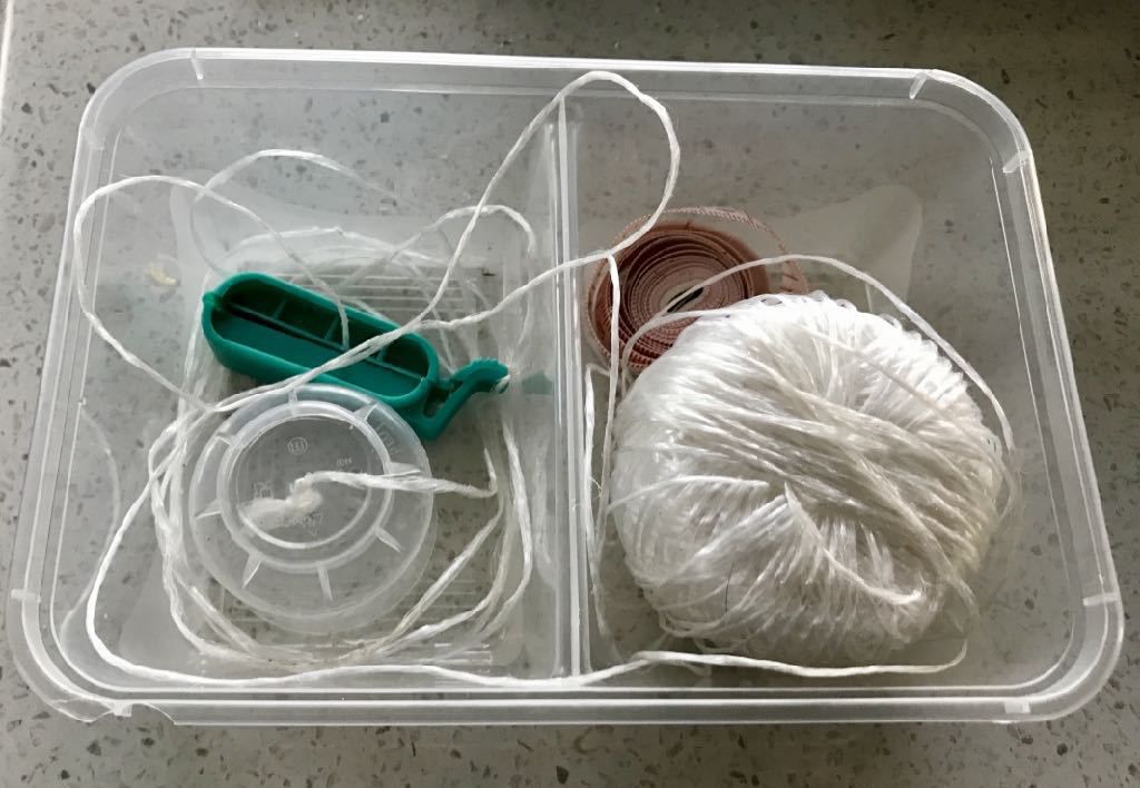 Water tank measuring kit: ball of string, small plastic cup, clip, tape measure.