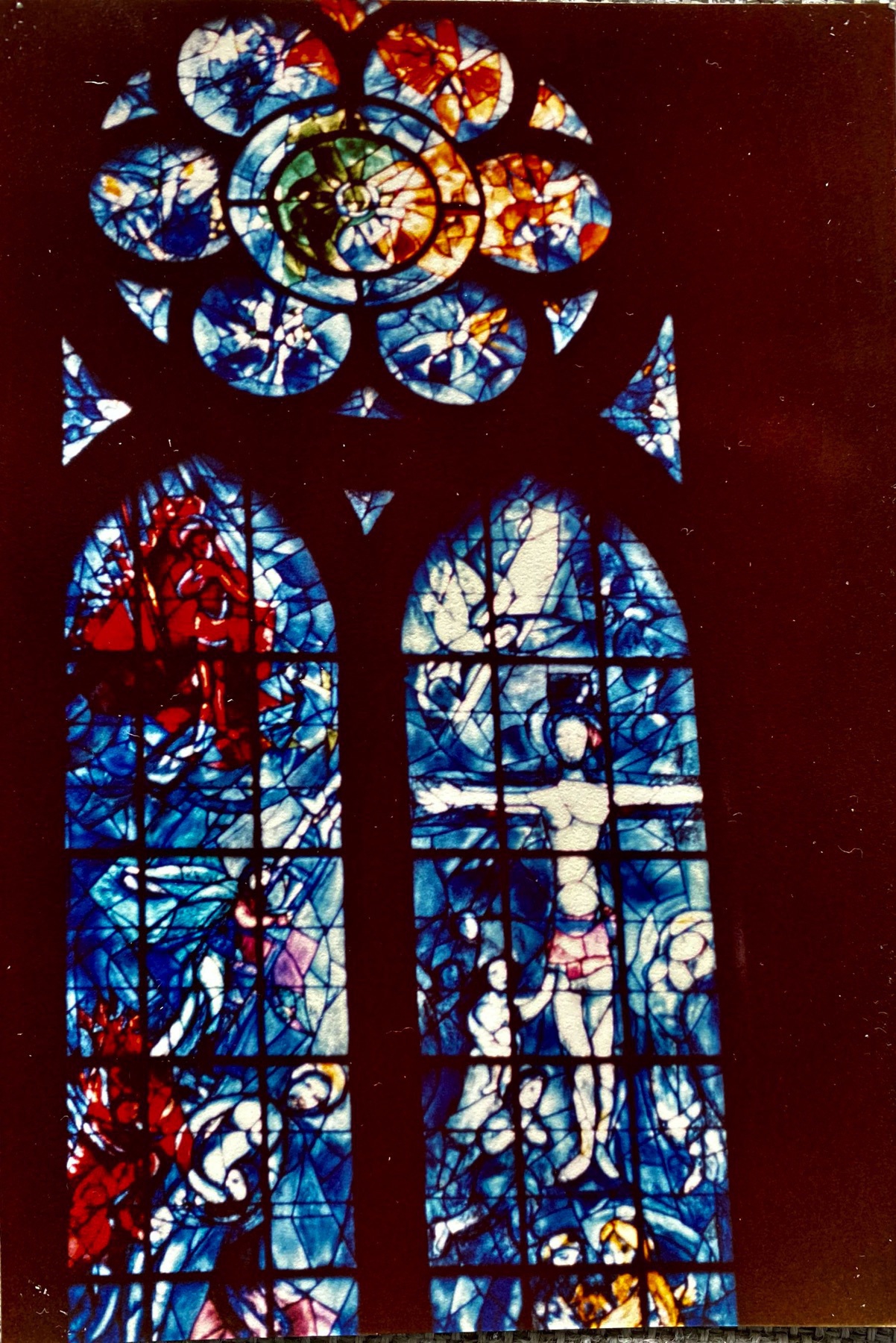 One cathedral window in stained glass with a predominant blue colour. 