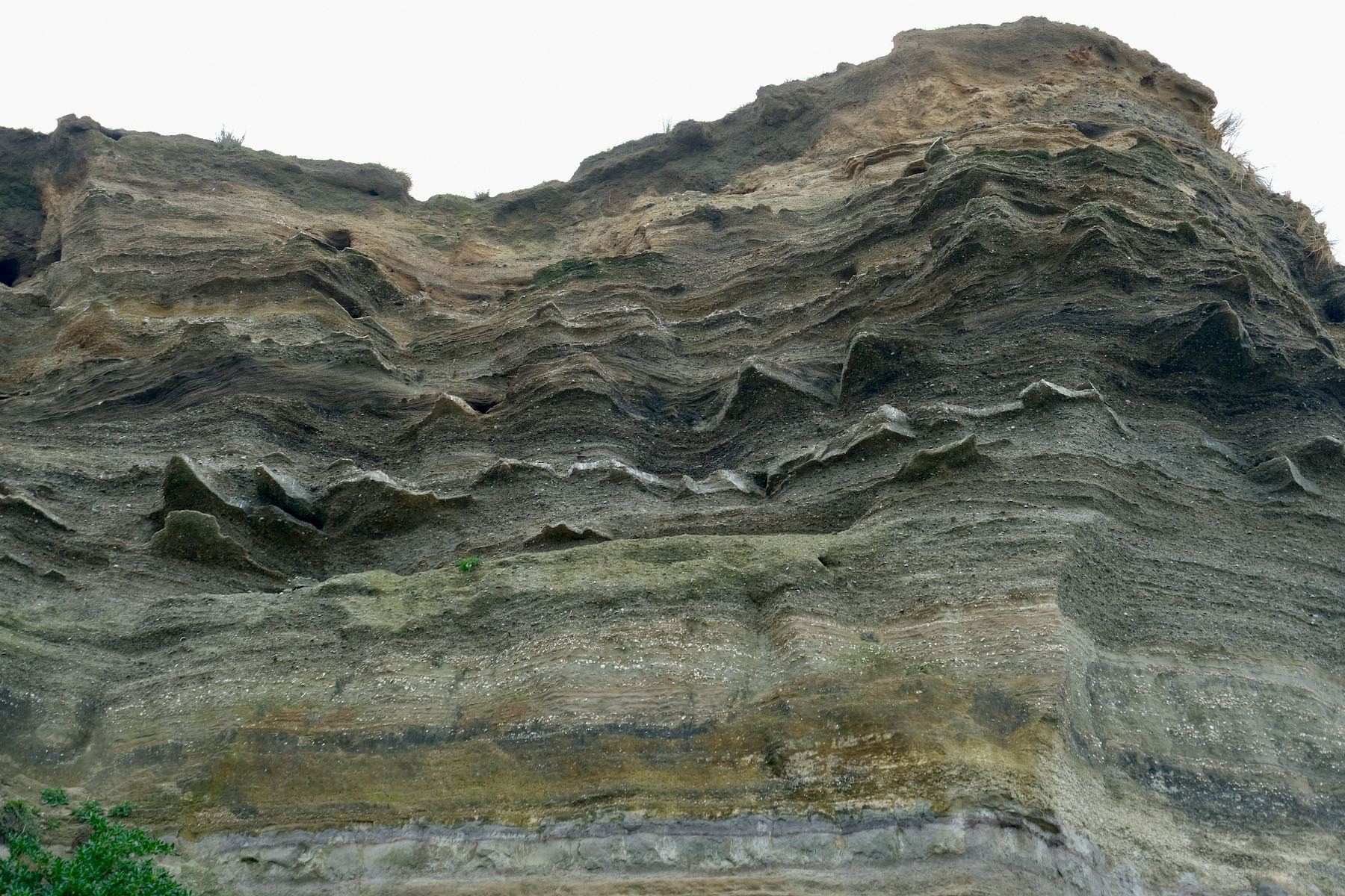 Cliff face showing layers of sediment etc. 