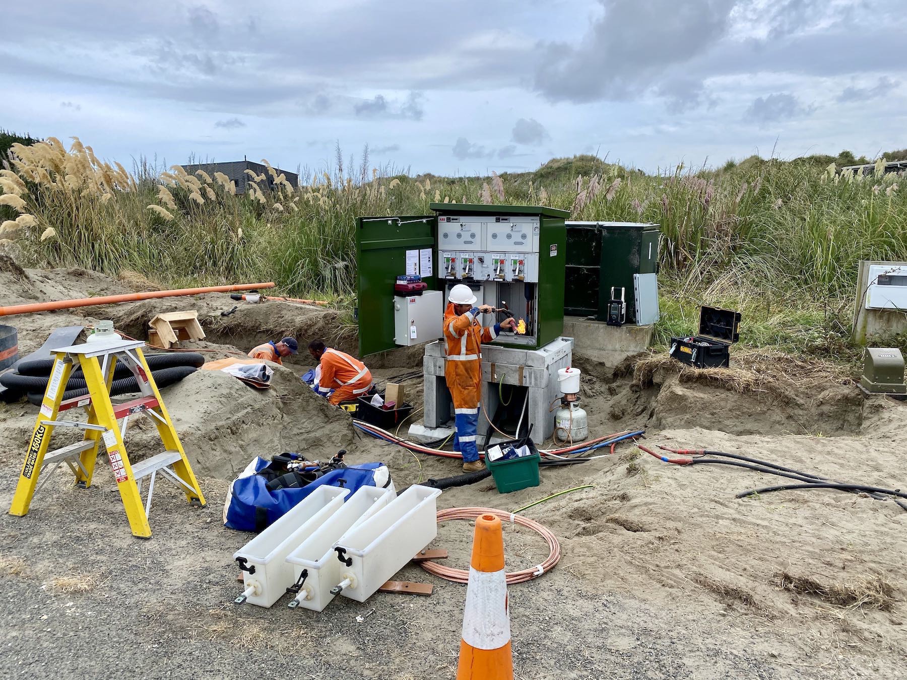 Workers install a new roadside power switch. 