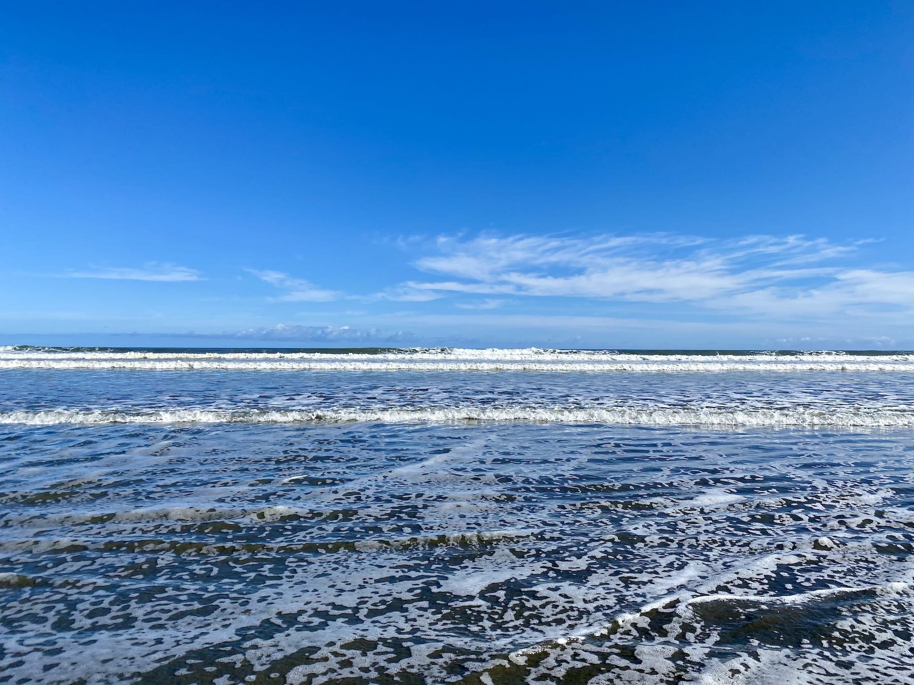 ANother view of sea at the edge of the sand. 