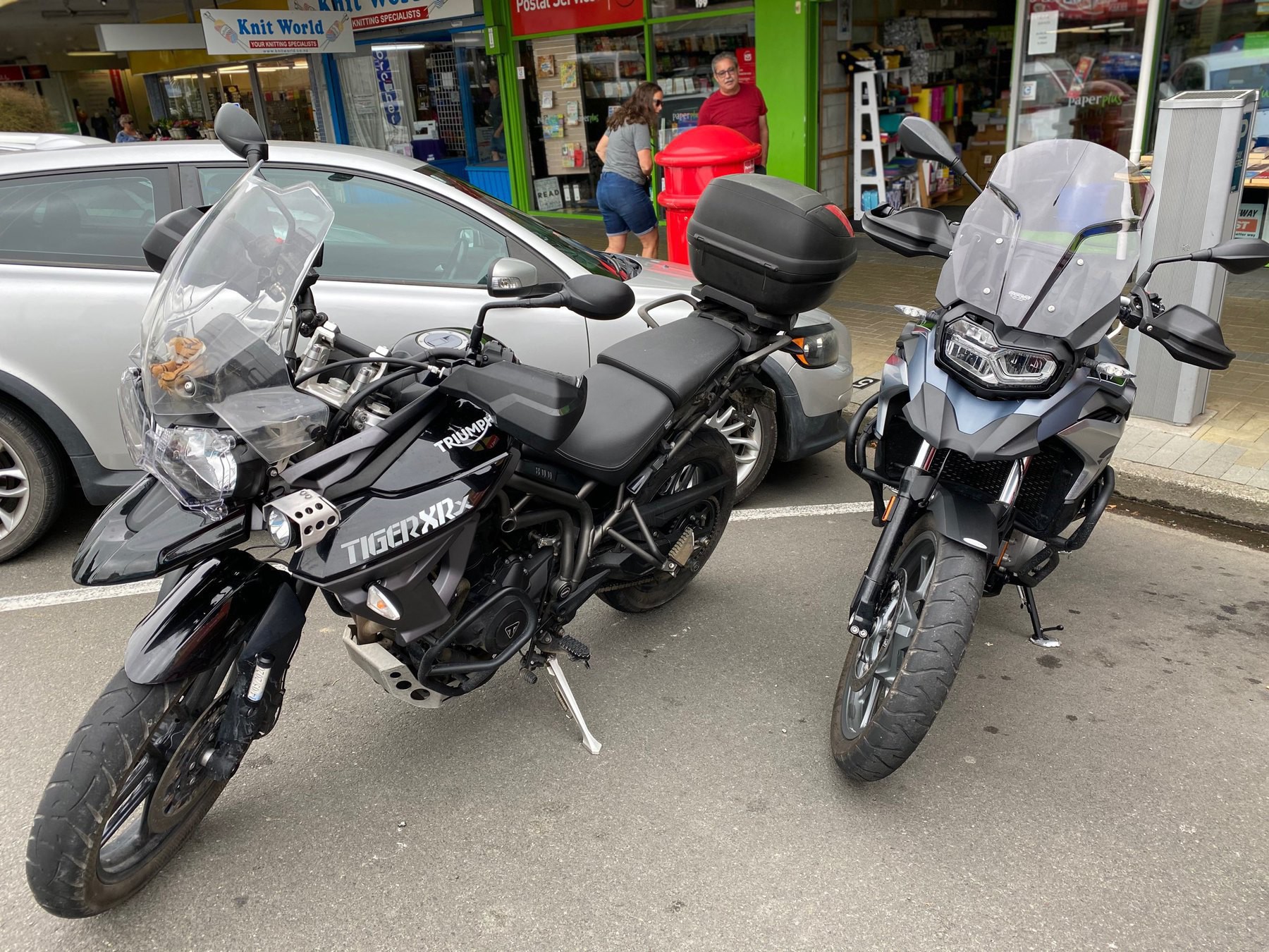 Two large motorcycles parked in a town