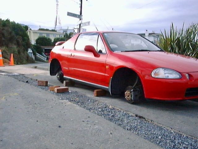 Car on bricks with wheels gone. 