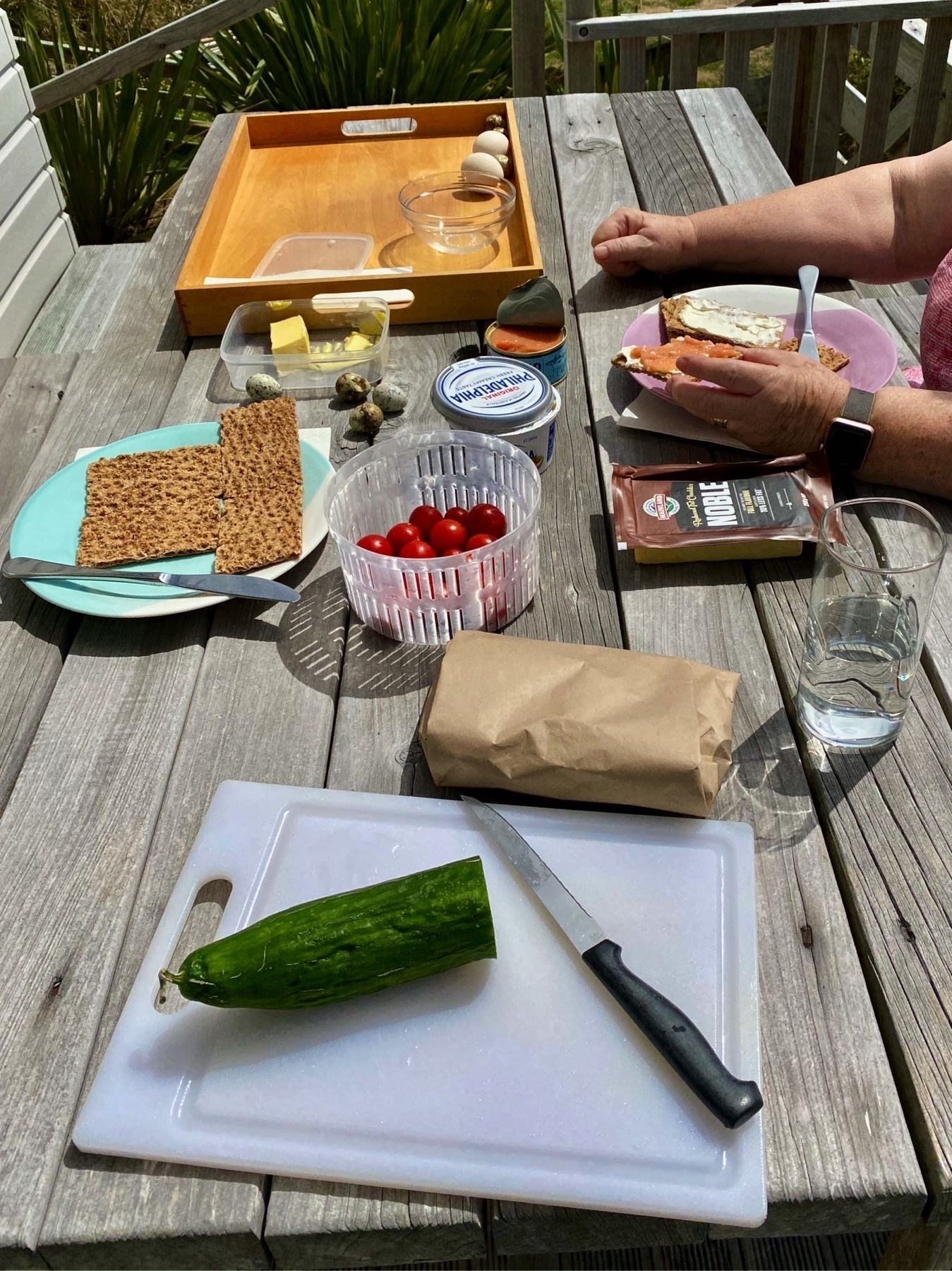 Picnic table in the sun with Swedish breakfast ingredients. 