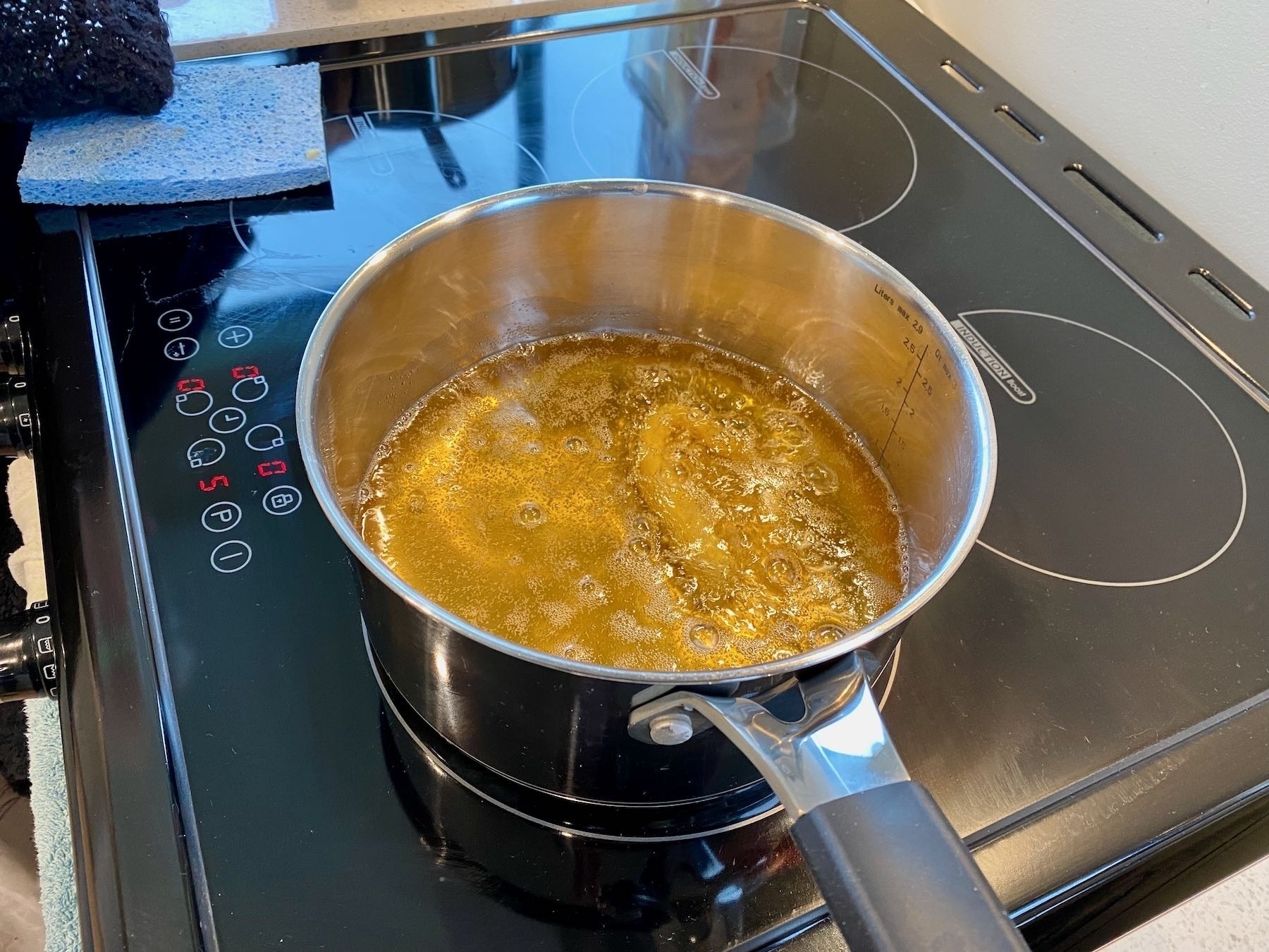 A couple of churros in the deep-fry oil. 