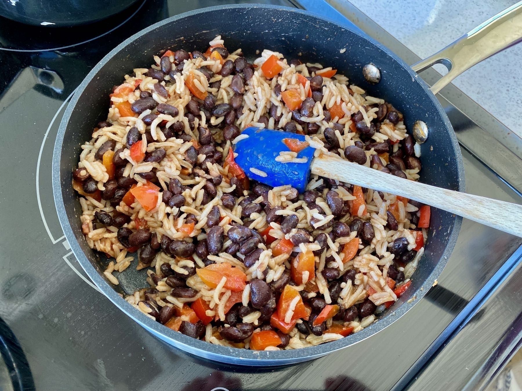 Beans and rice cooking in a frypan. 