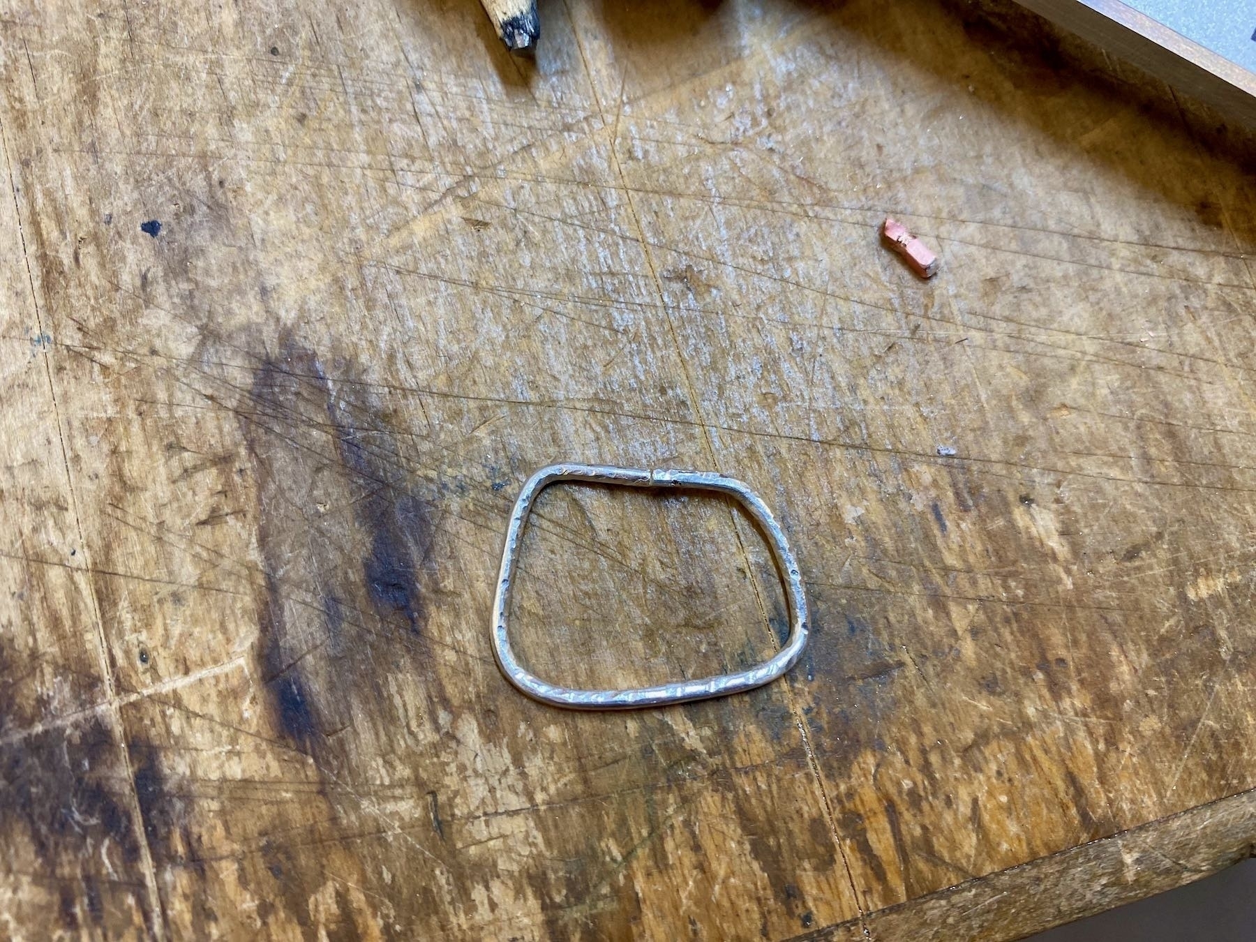 A rectangular silver ring early in the process. 