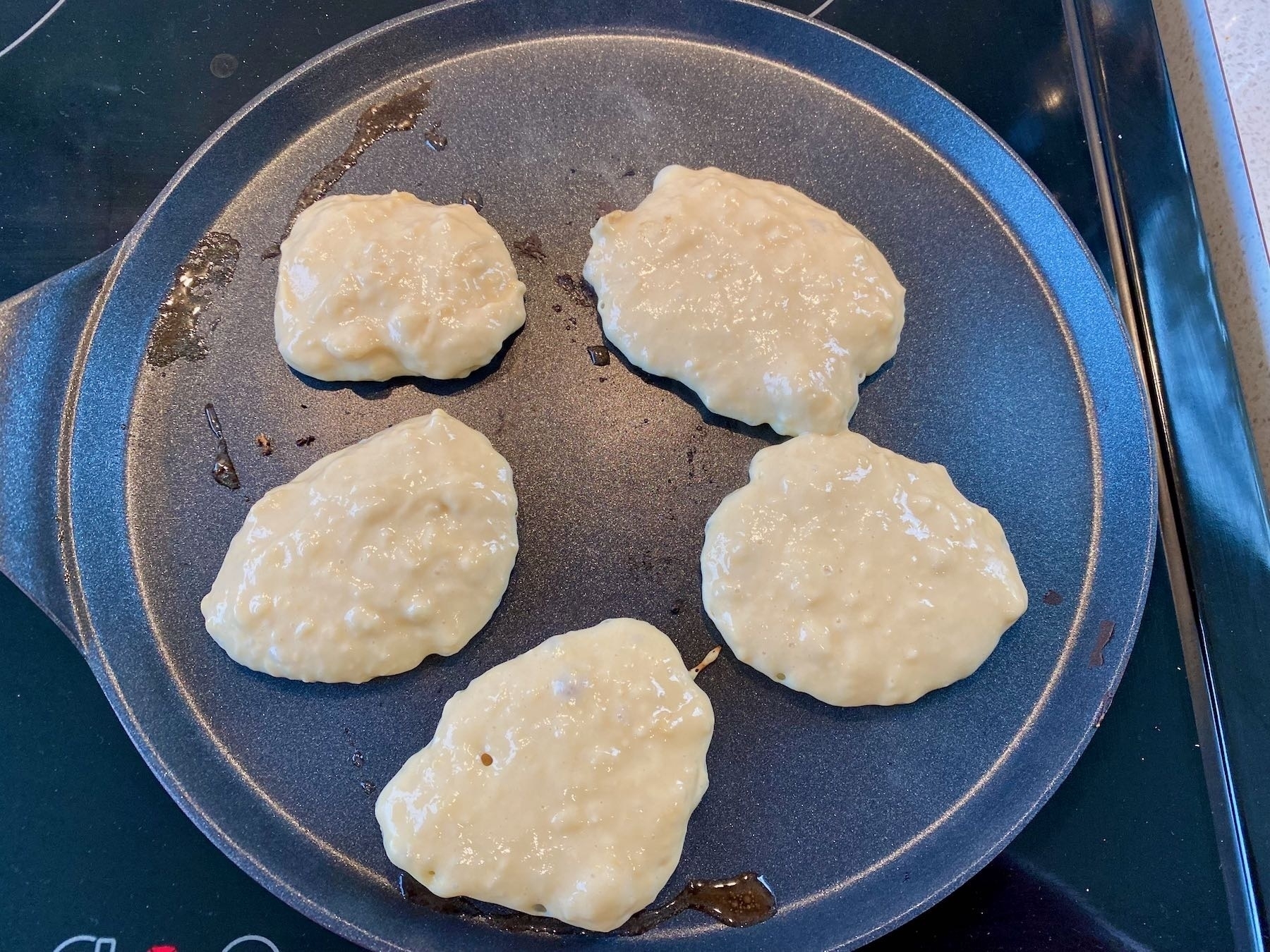 Drop scones cooking on the griddle. 