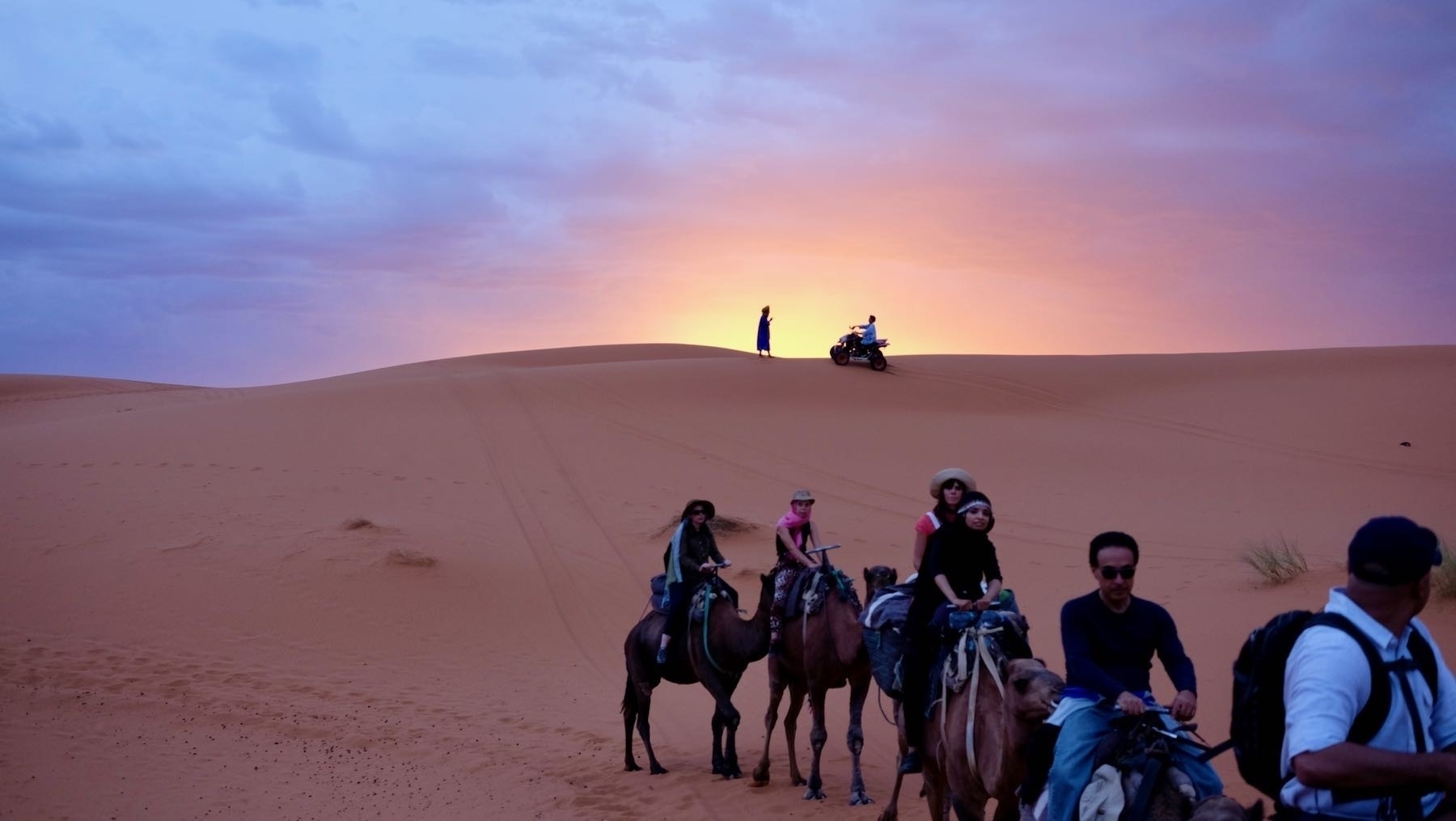 Sunrise in the desert with camel train. 