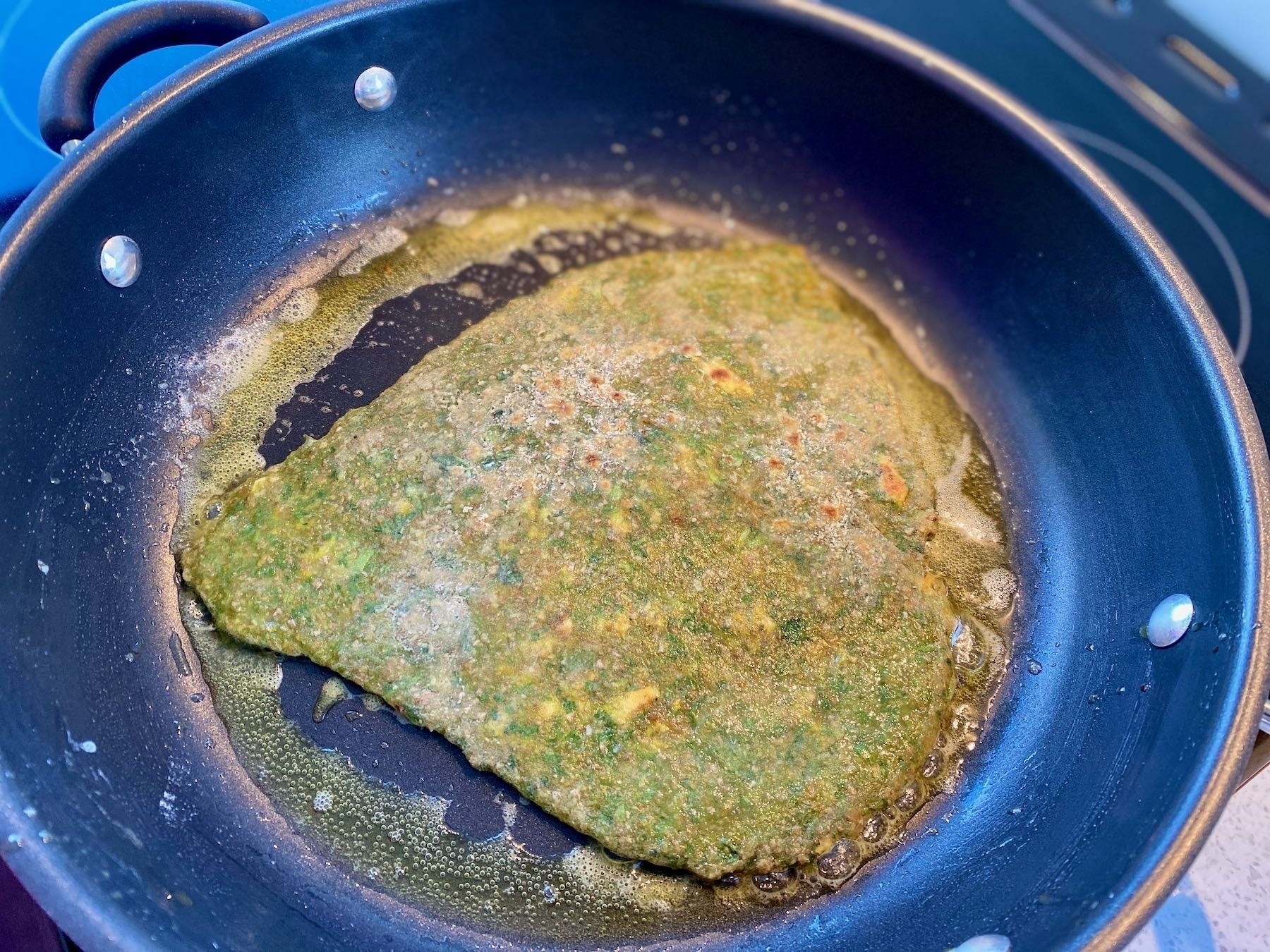Paratha cooking in a pan. 