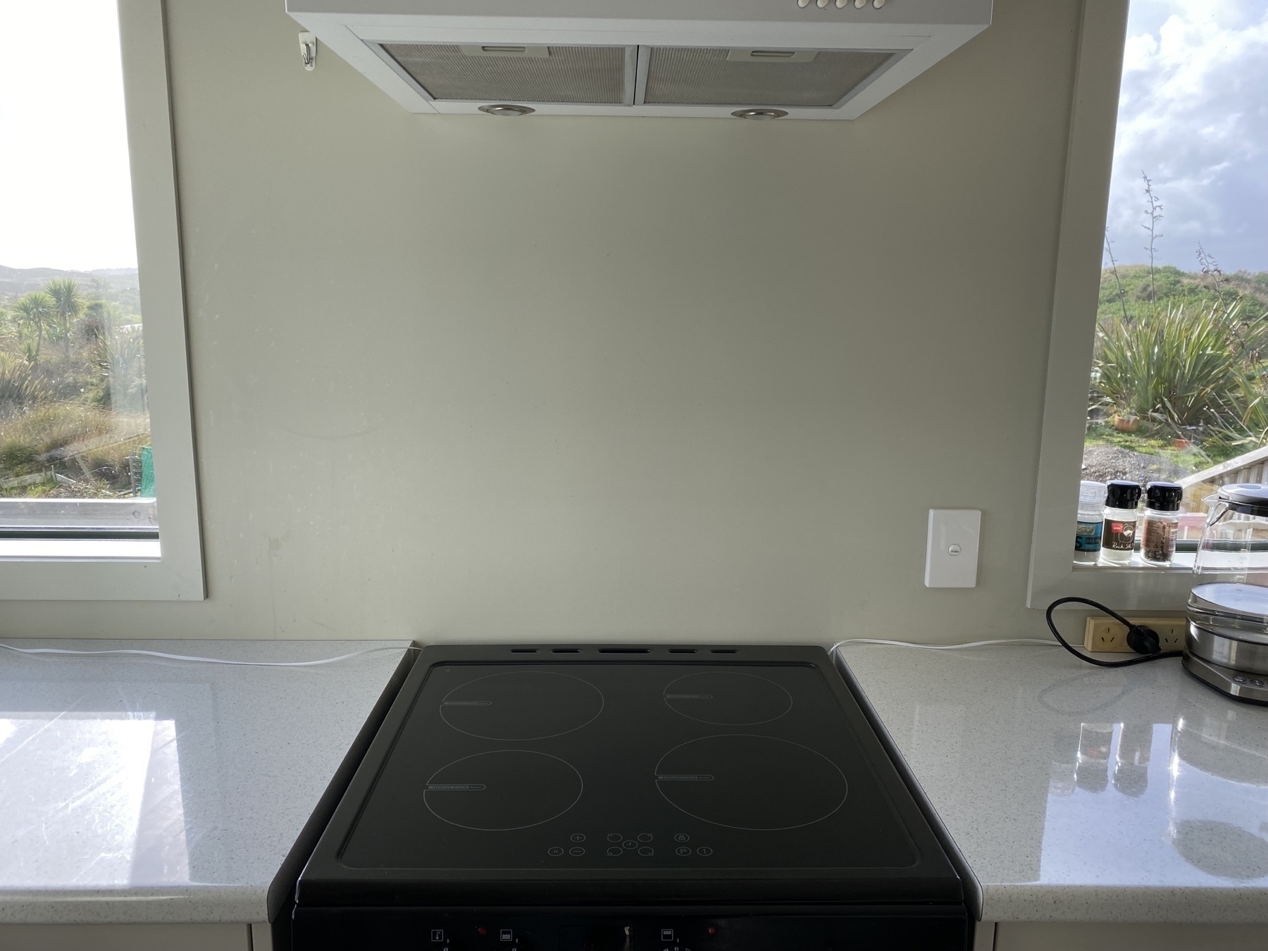 Blank wall behind oven. 