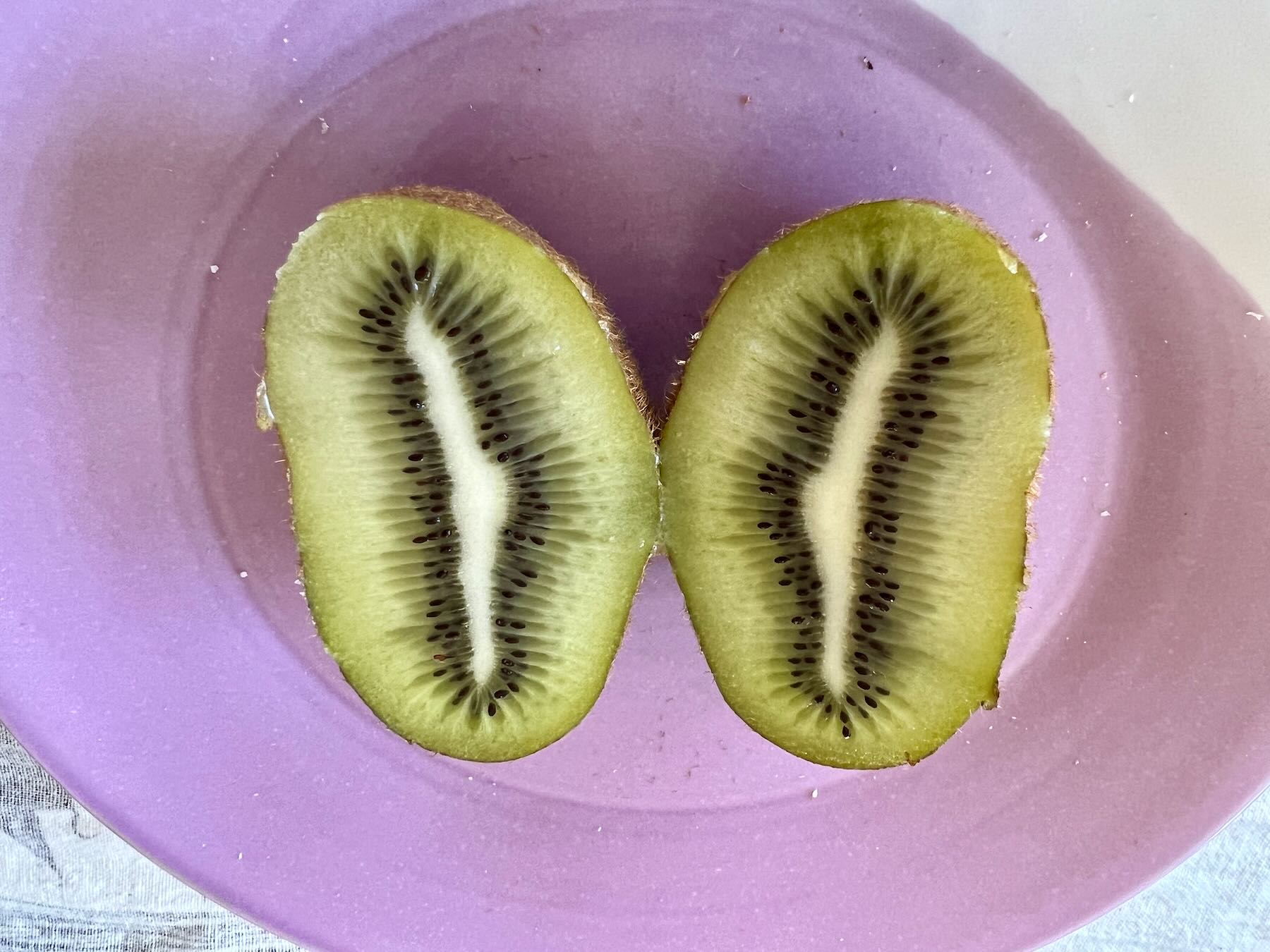 Large kiwifruit on a plate. 