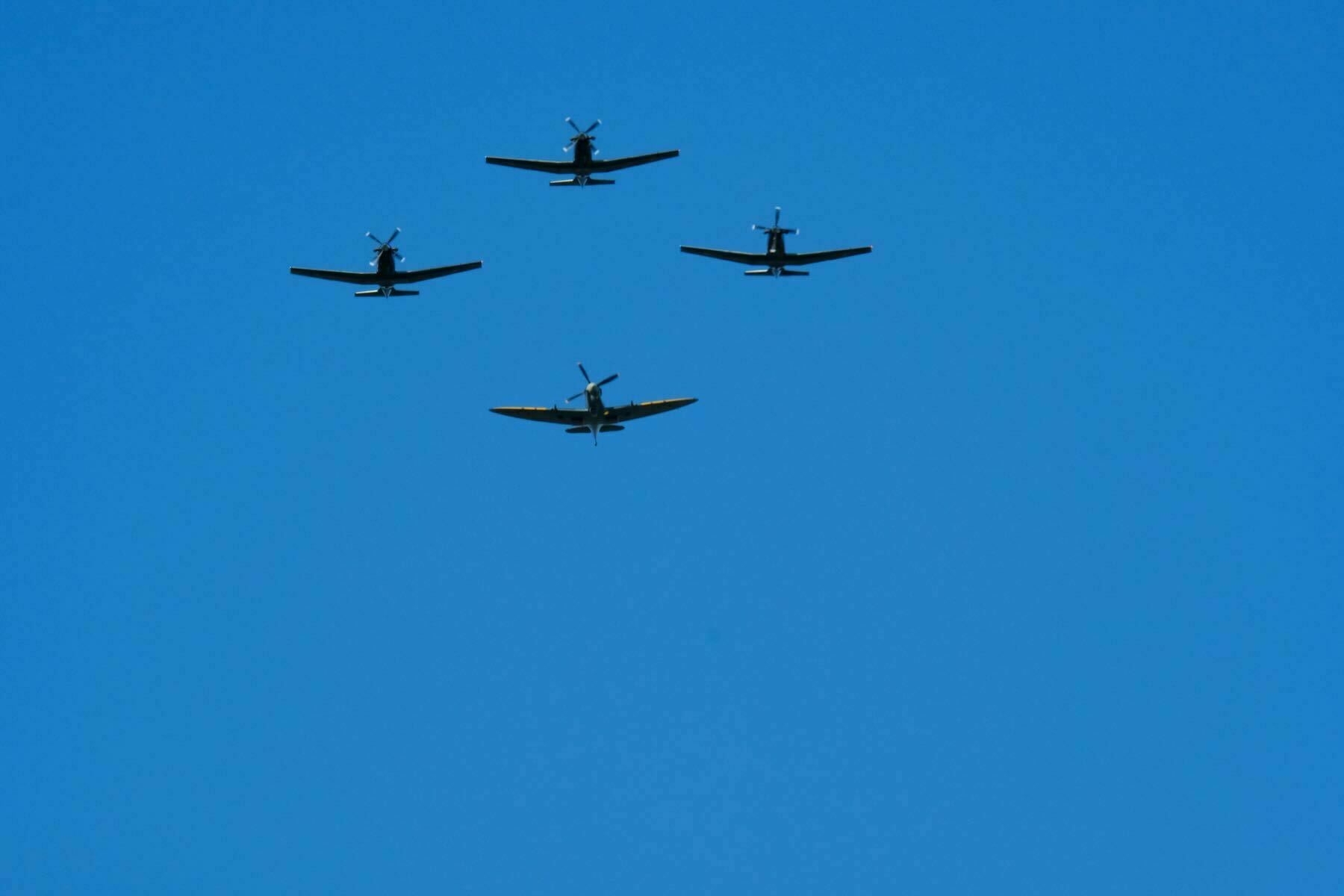 4 planes in a tight diamond formation heading straight for the camera.  