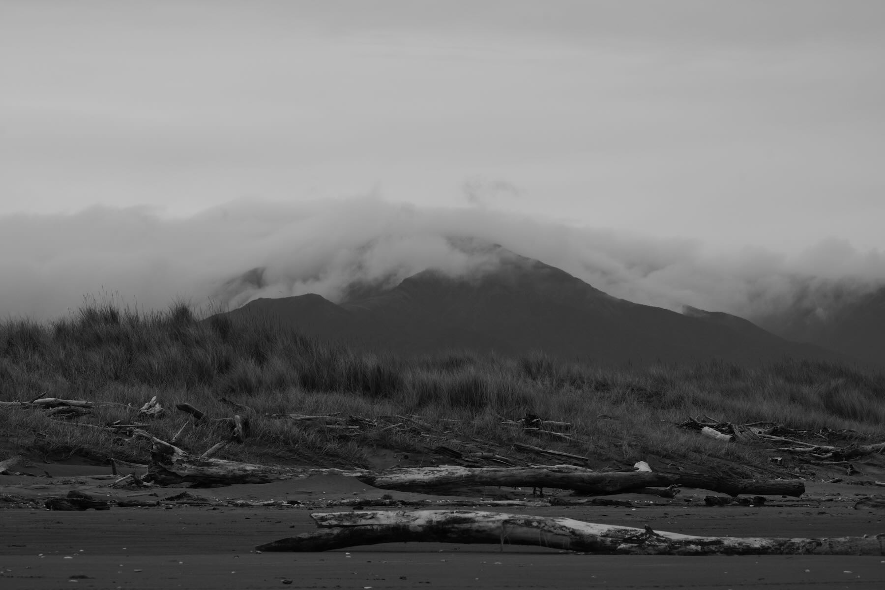 Cloud clad Tararua peak from the beach. 
