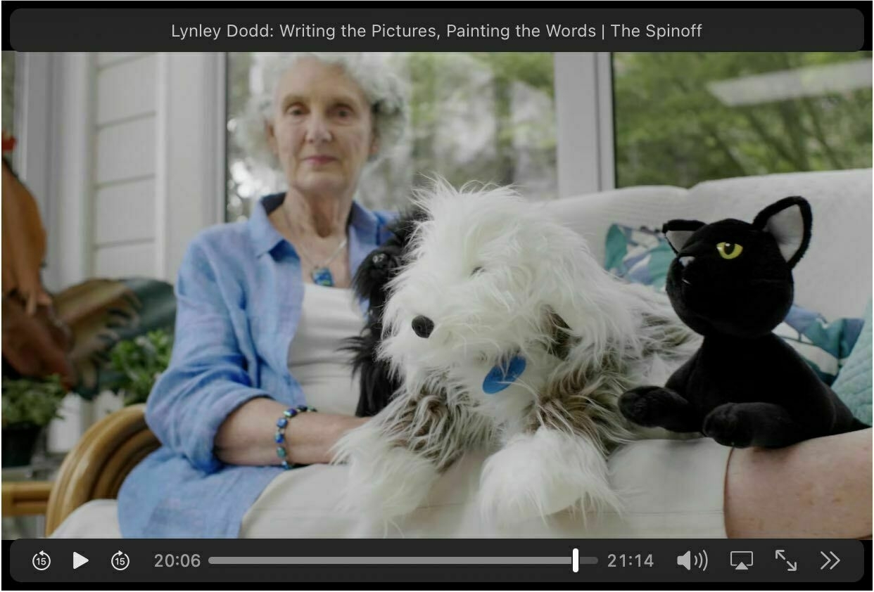Screenshot showing author Lynley Dodd with some of her characters as stuffed toys.