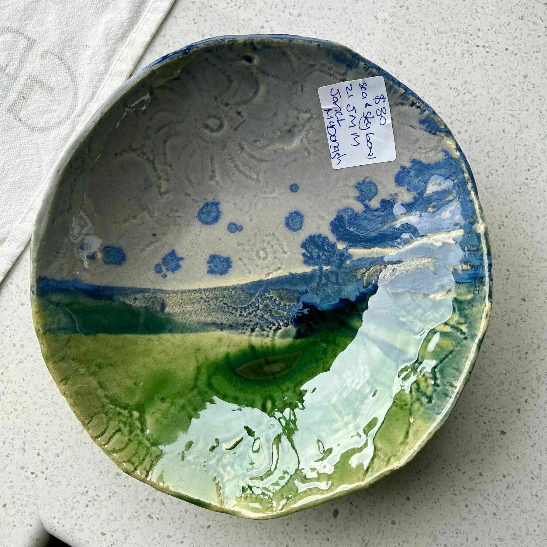 Shaoow pottery bowl loosely depicting sea and sky. 
