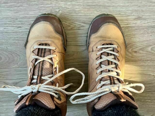 Two boots on my feet with different lacing patterns. 
